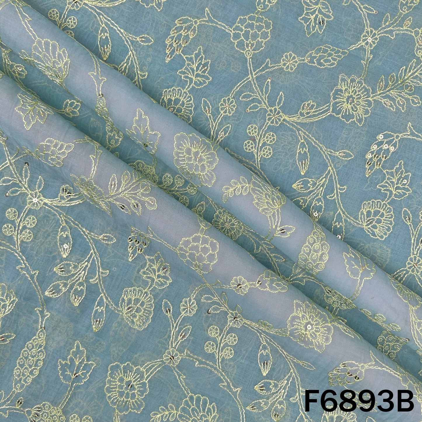 Detailed blue Chanderi fabric view highlighting fine embroidered floral lines and festive texture