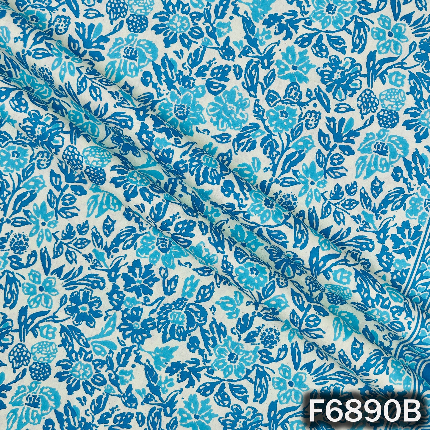 Blue cotton fabric F6890B captured closely to highlight its crisp floral printed texture