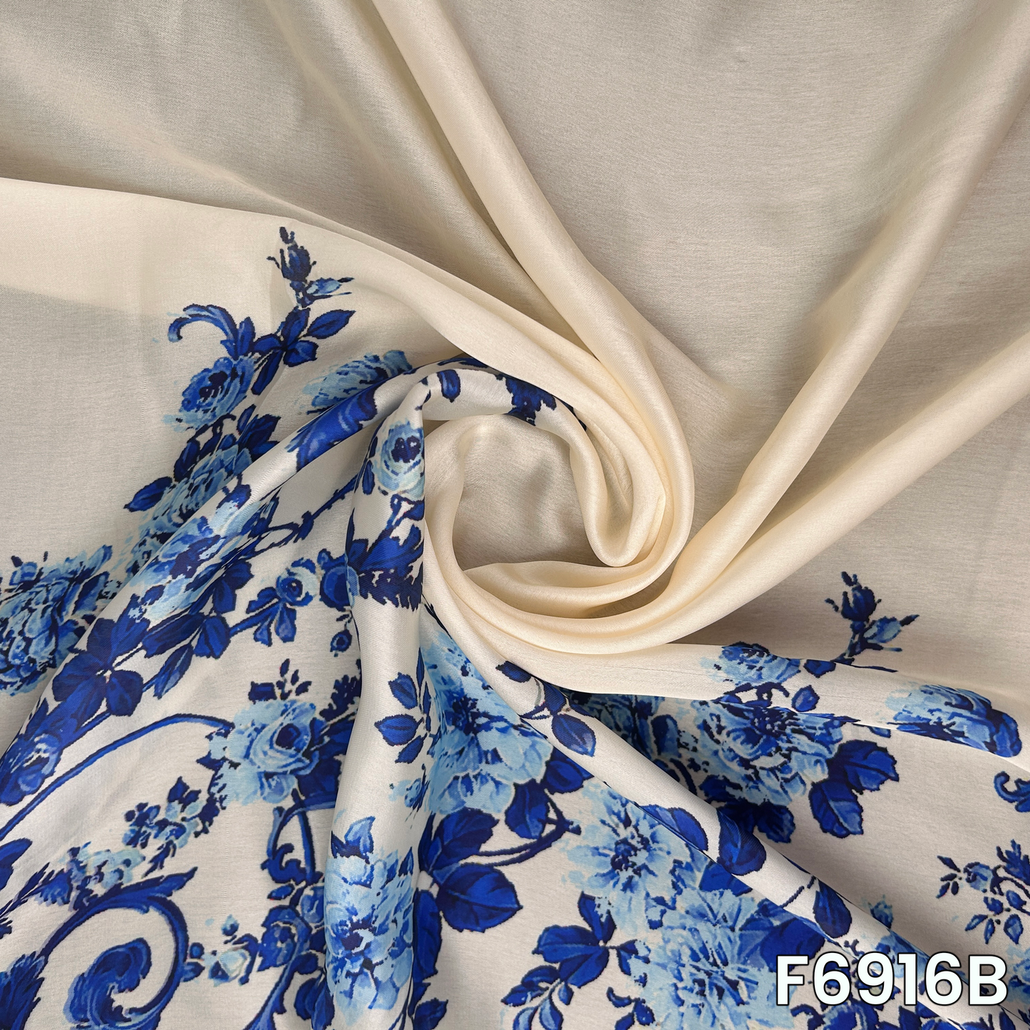 Draped F6916B fabric highlighting silky folds, bold blue flowers and smooth premium shine