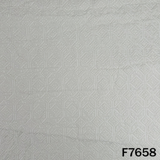Ivory raw silk fabric with delicate tone-on-tone embroidery and textured finish