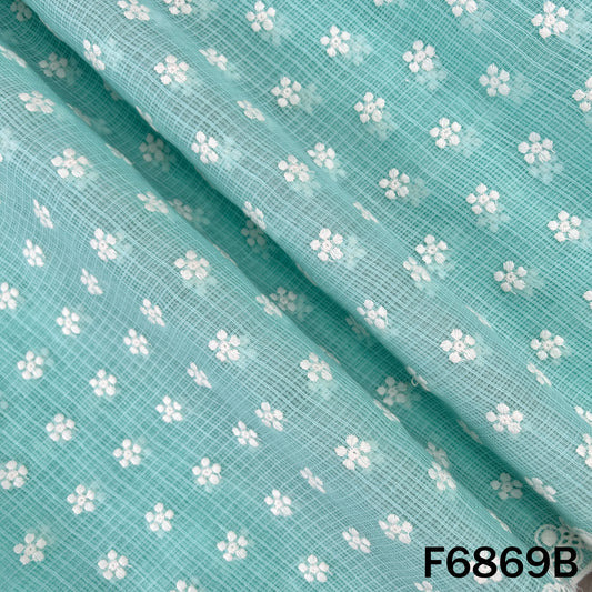 Detailed view of thread embroidered aqua Kota cotton fabric with floral design