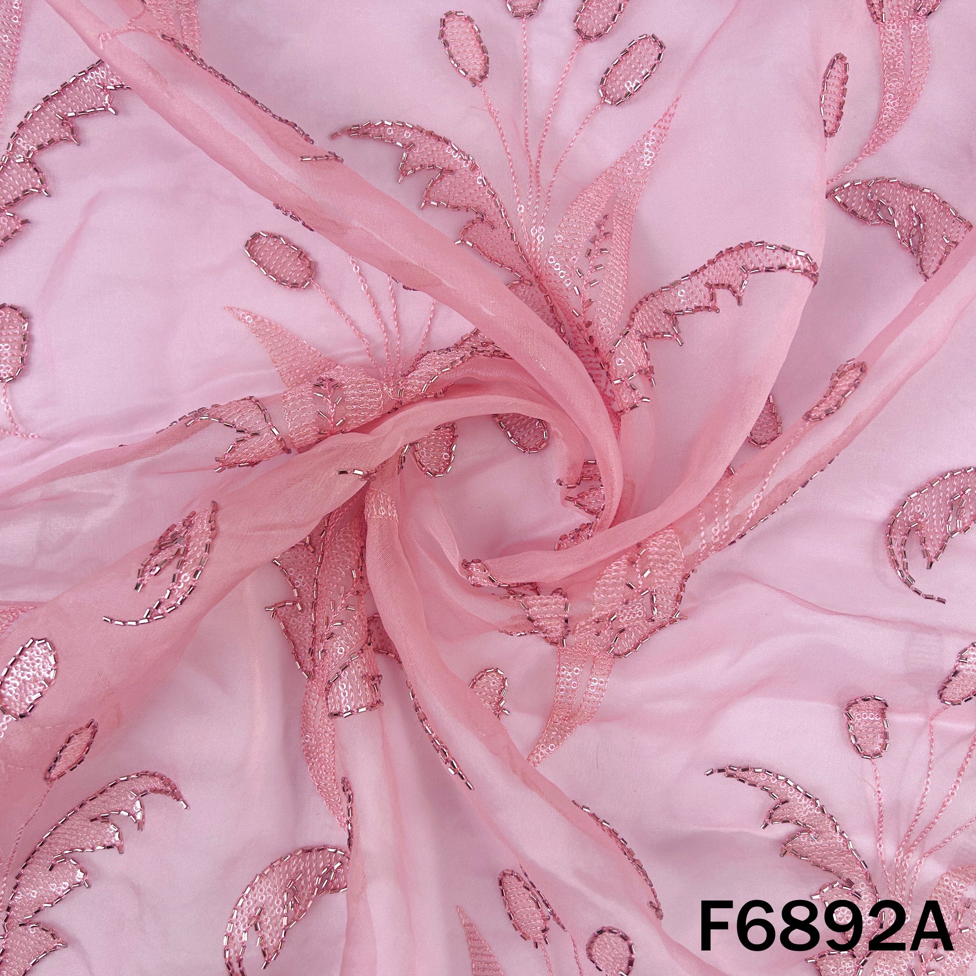 Detailed pink organza fabric view showing floral embroidery with fine sequins and cut dana accents