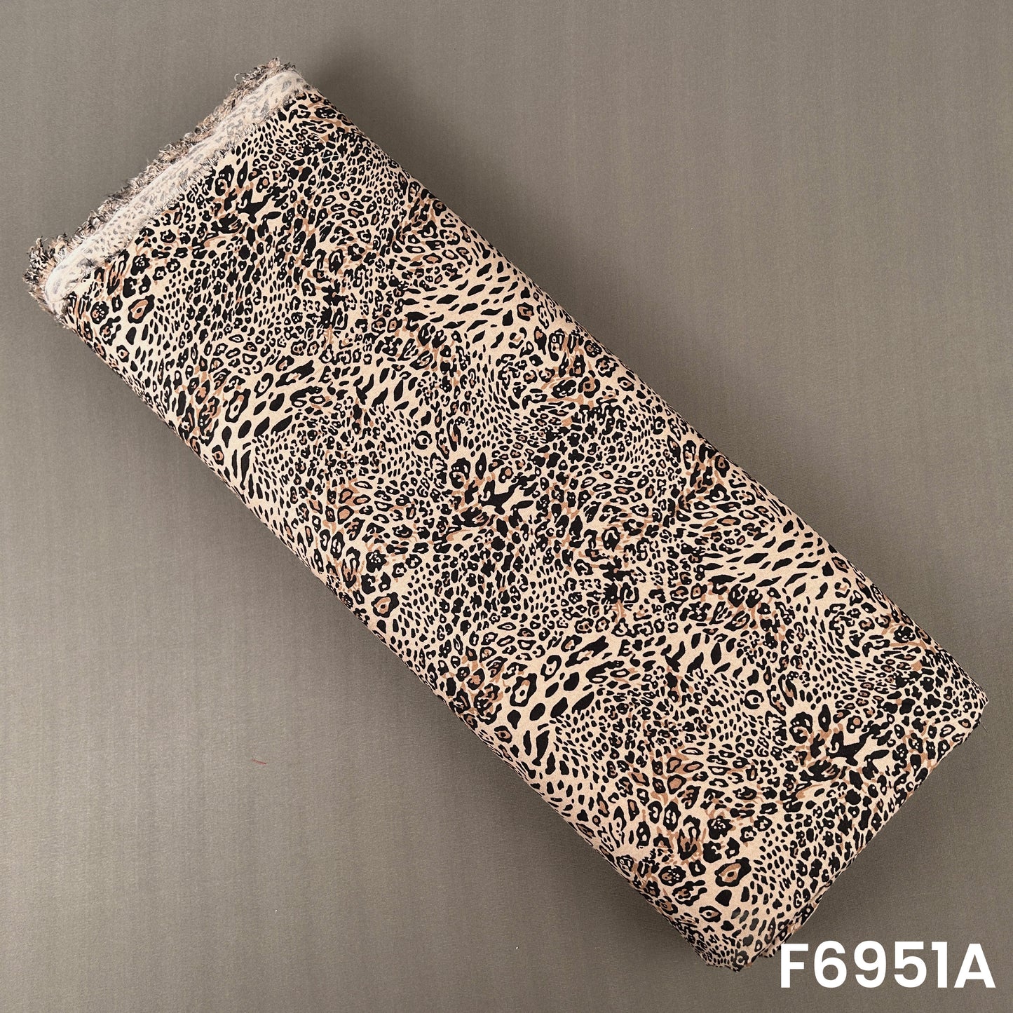 Beige and brown rayon fabric F6951A featuring dense leopard spots for bold contemporary clothing