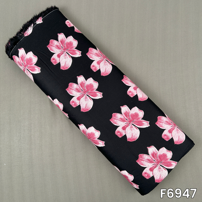 Black printed rayon fabric F6947 featuring large pink flowers scattered across a smooth dark base