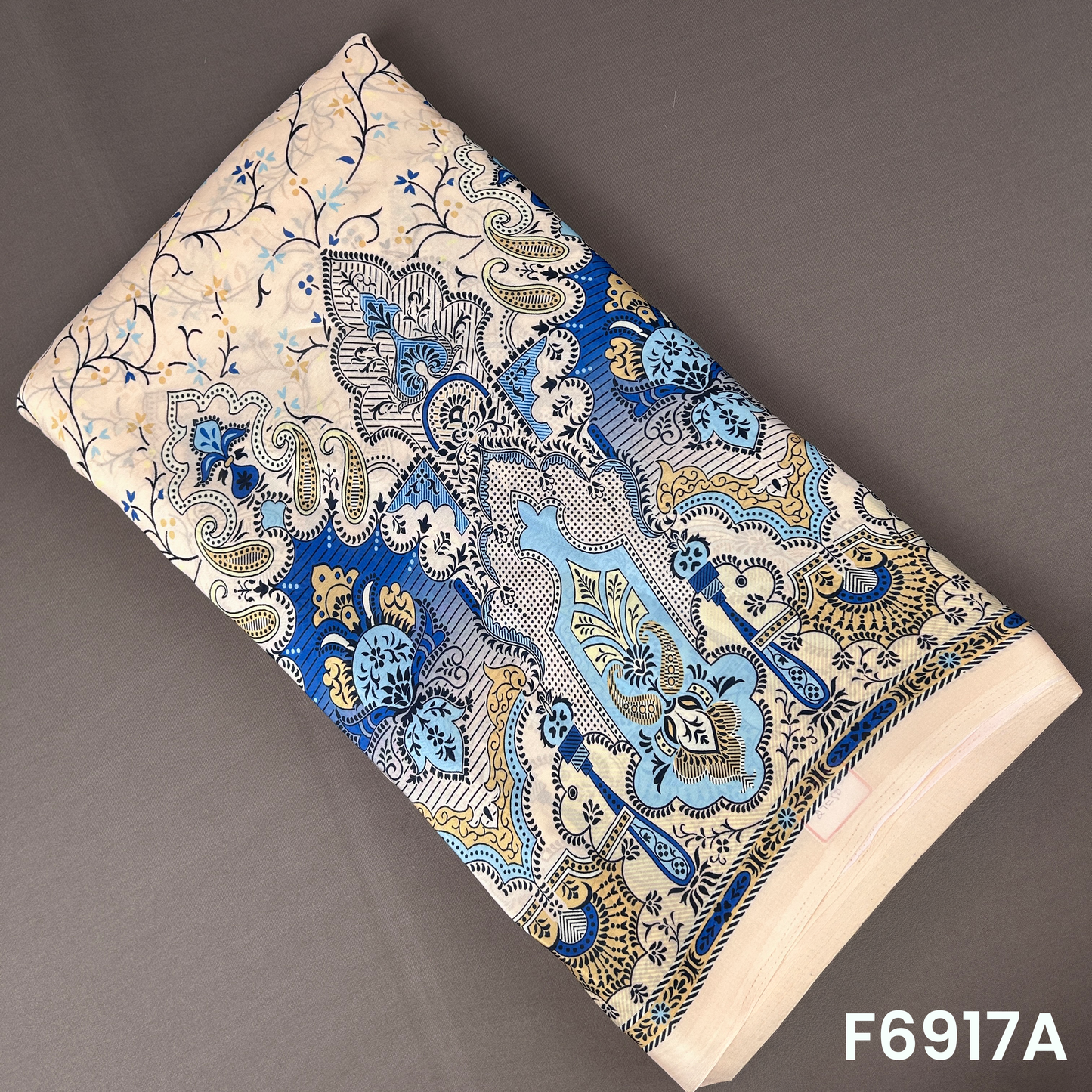 F6917A Crepe Satin fabric featuring royal blue paisley motifs, floral detailing and a smooth glossy base