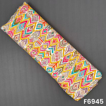Folded rayon fabric F6945 displaying bright geometric diamonds in teal, yellow, pink, orange and olive tones
