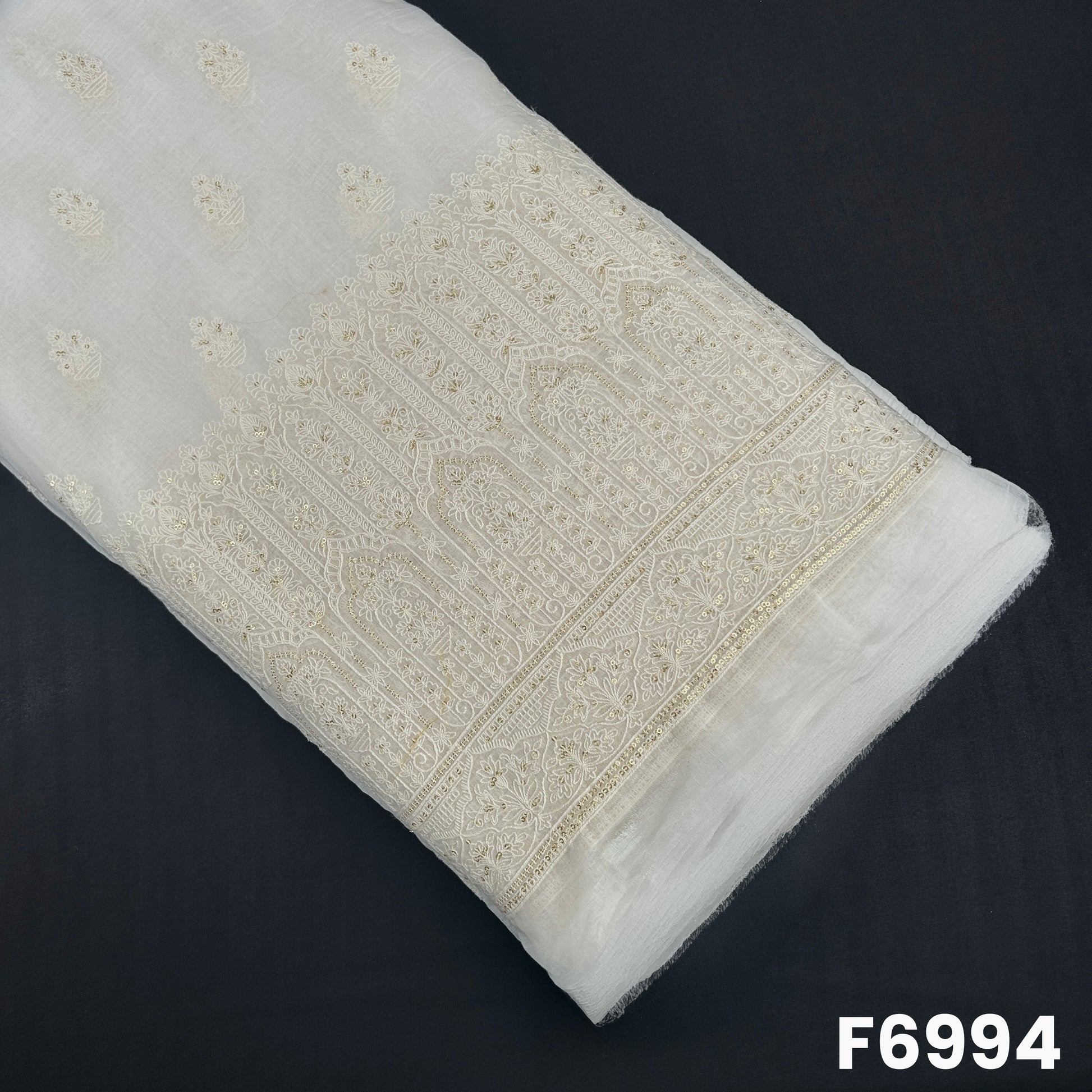 Dyeable Chanderi Silk fabric F6994 with floral butti embroidery and an ornate thread sequins border on an ivory base