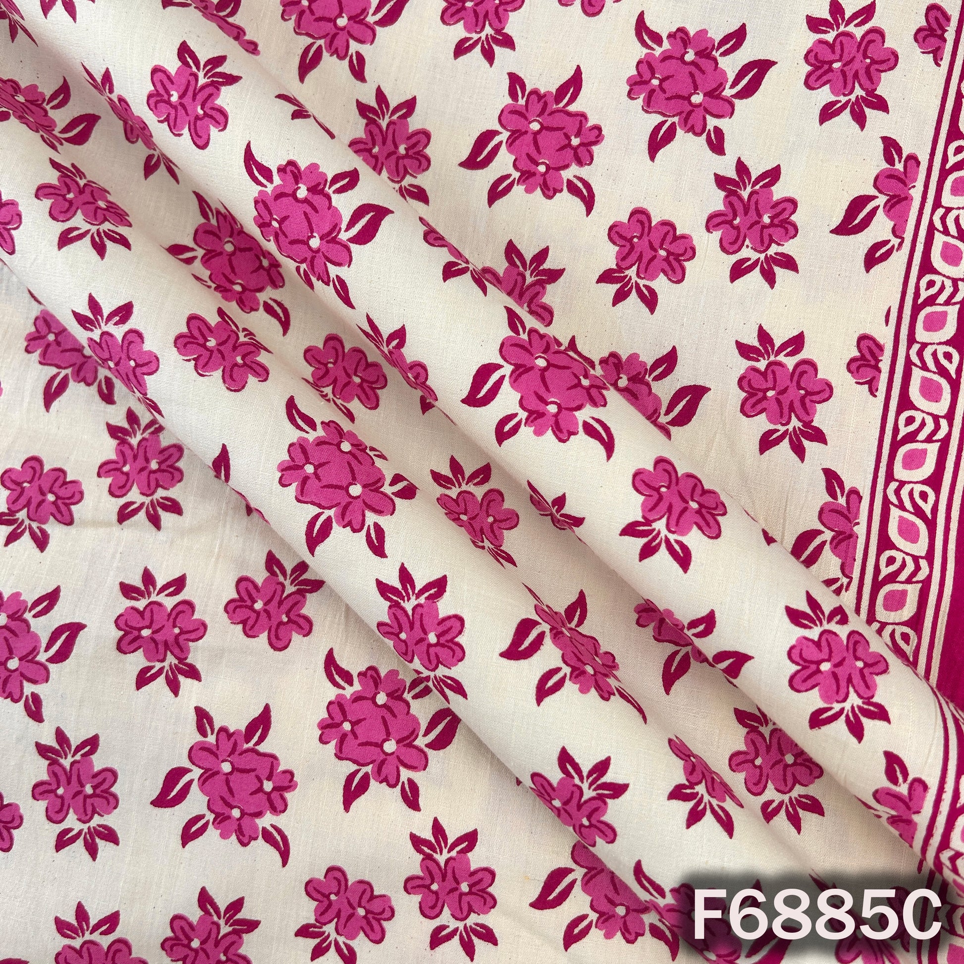 Pink cotton fabric F6885C captured closely to show its fresh floral print and soft fabric surface
