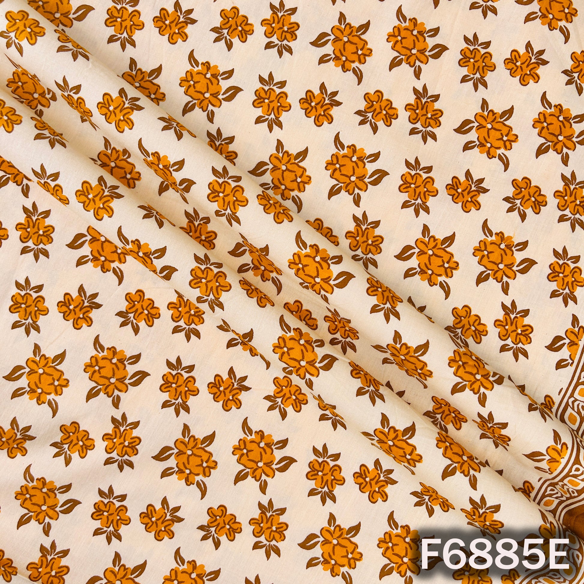 Detailed view of F6885E orange cotton fabric showing clear flower motifs and natural cotton texture