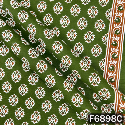 Close view of F6898C green cotton fabric displaying clean motif placement and smooth cotton texture