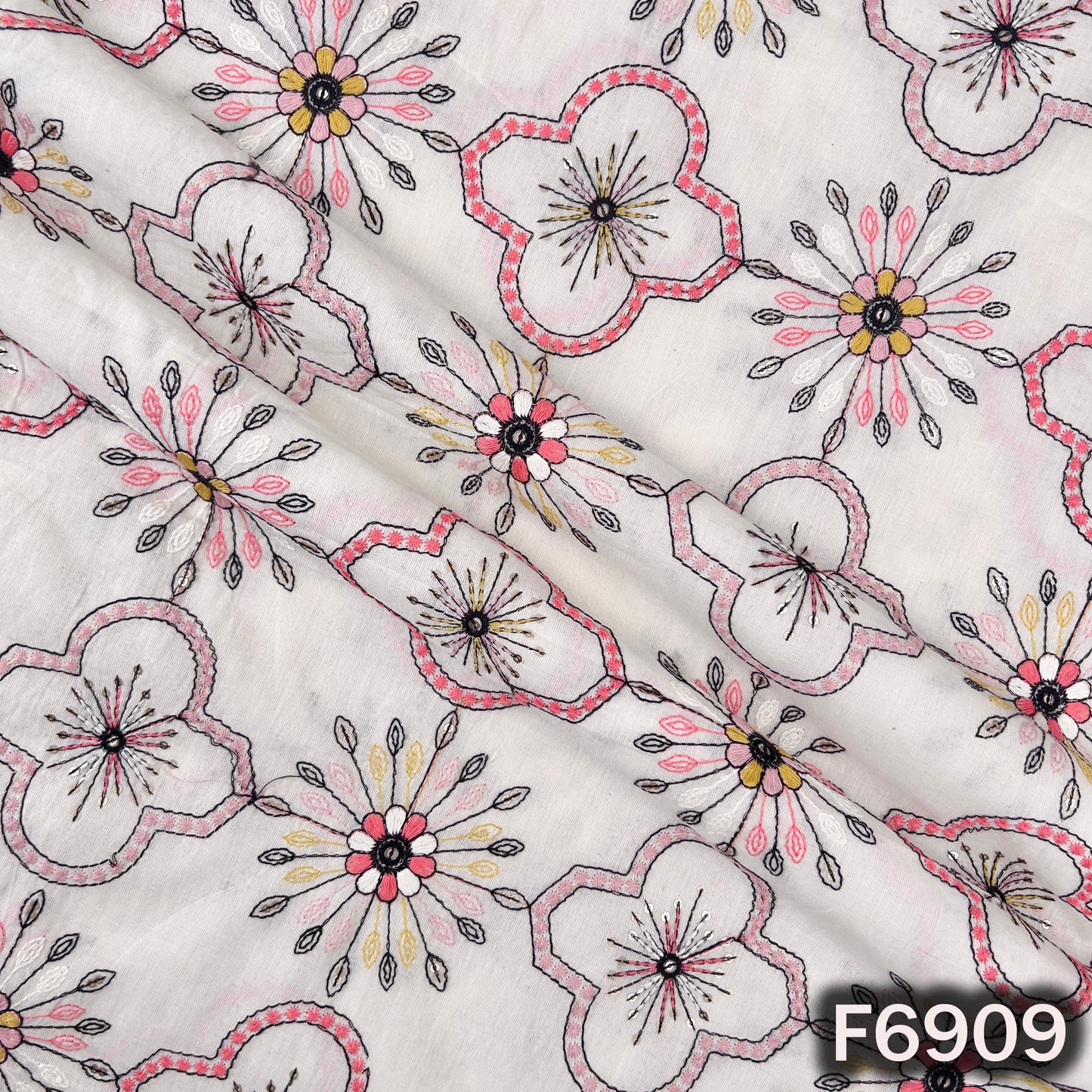 Draped Kora cotton fabric F6909 revealing lightweight folds, floral embroidery and delicate shimmer finish