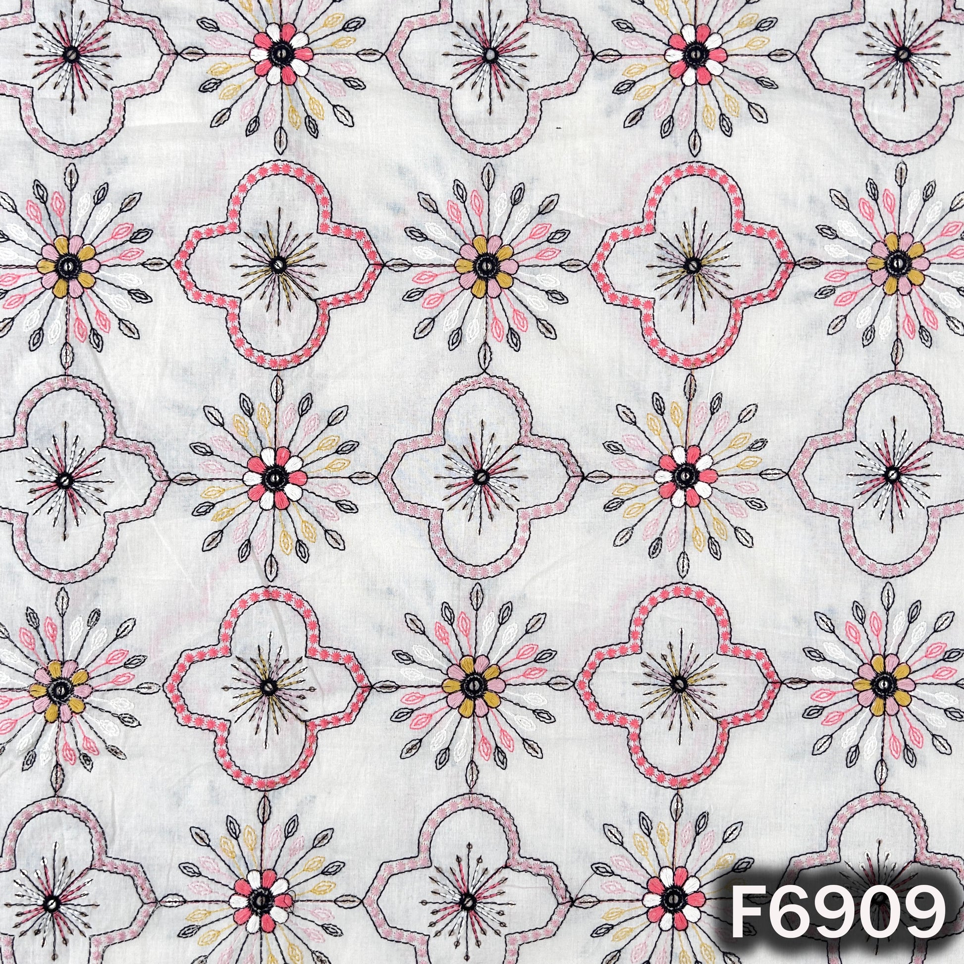 Close pattern view of F6909 showing outlined flower motifs, fine thread work and subtle sequin accents