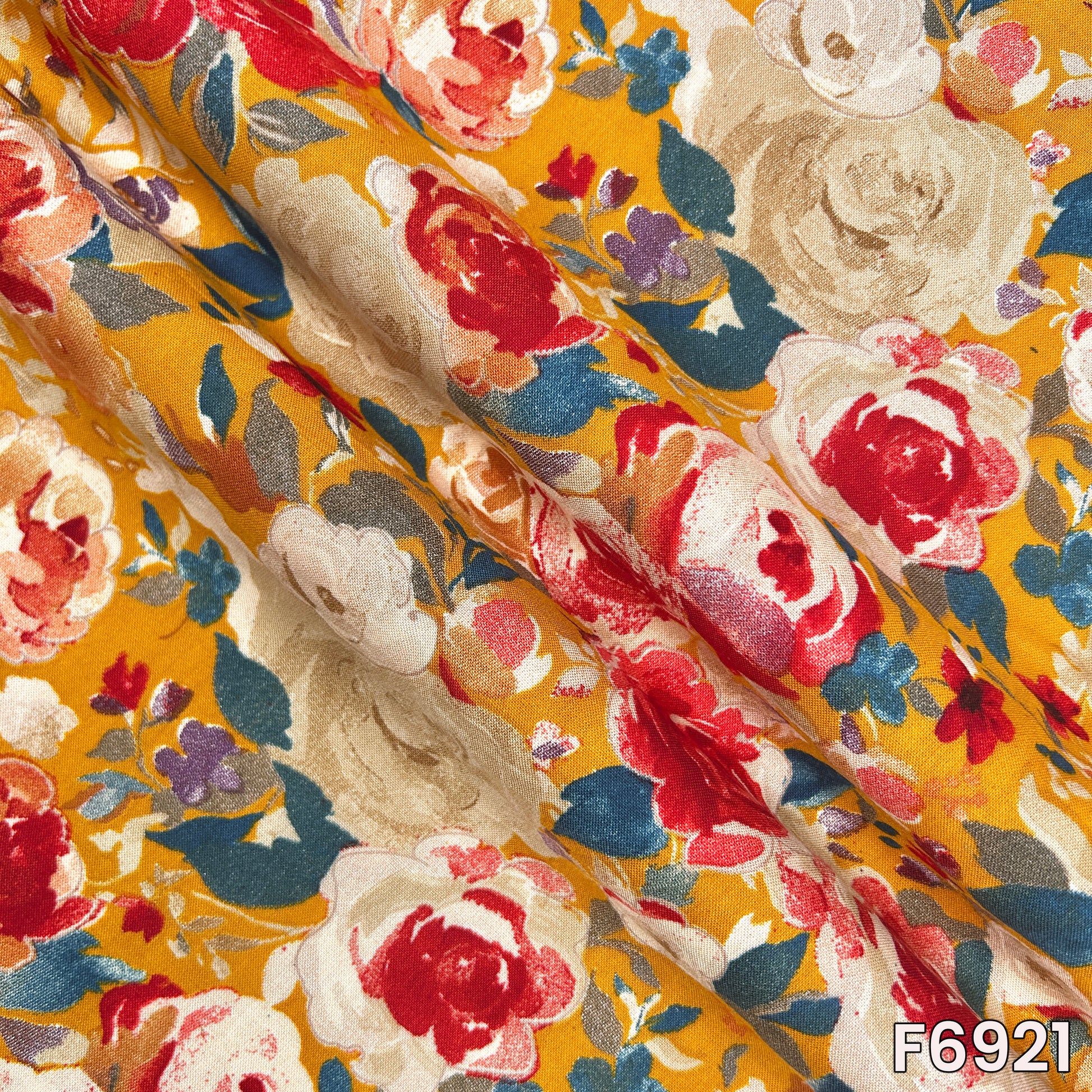 Draped F6921 rayon fabric highlighting smooth flow, lightweight texture and vibrant rose print styling