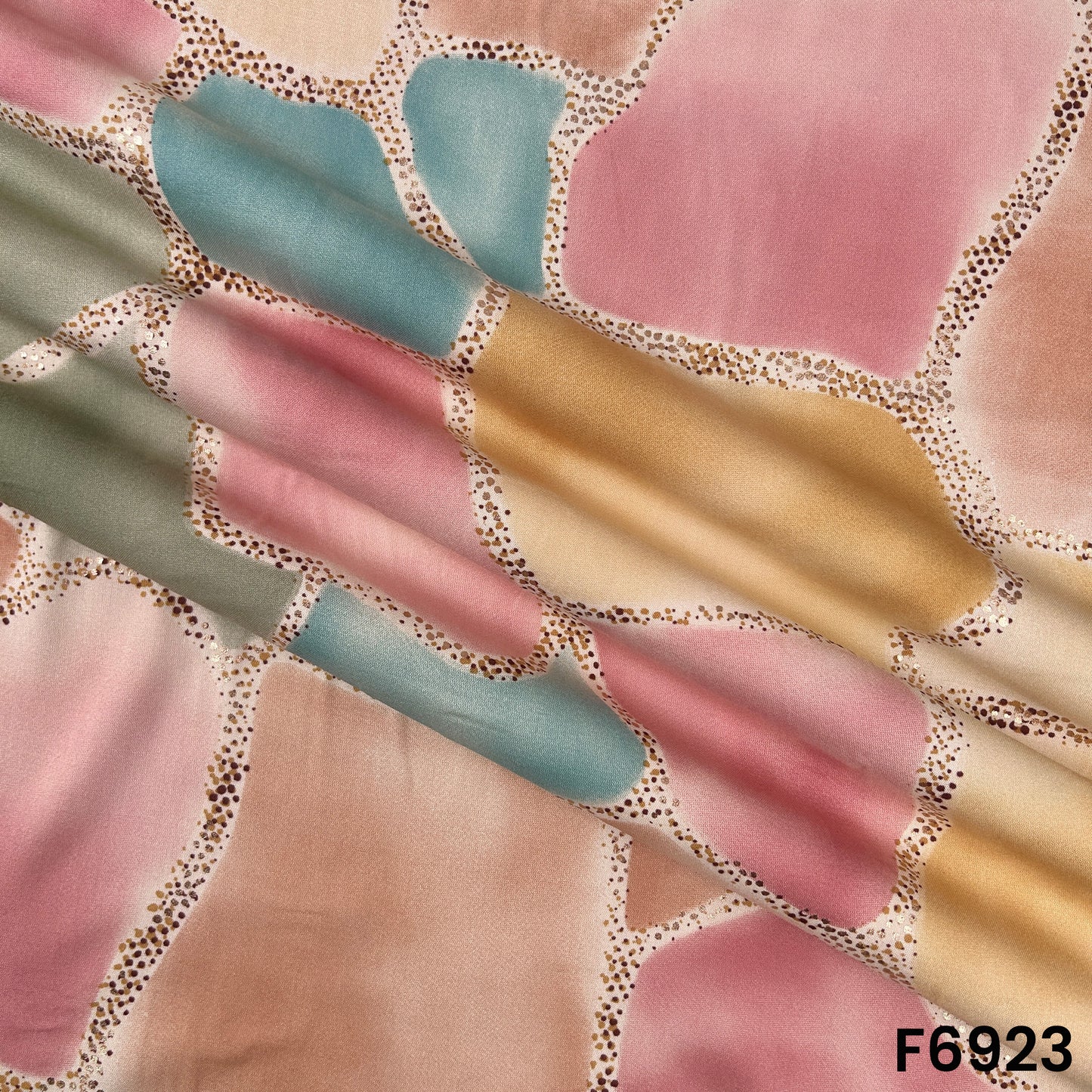 Draped F6923 rayon fabric highlighting fluid folds, pastel shades and elegant foil border detailing