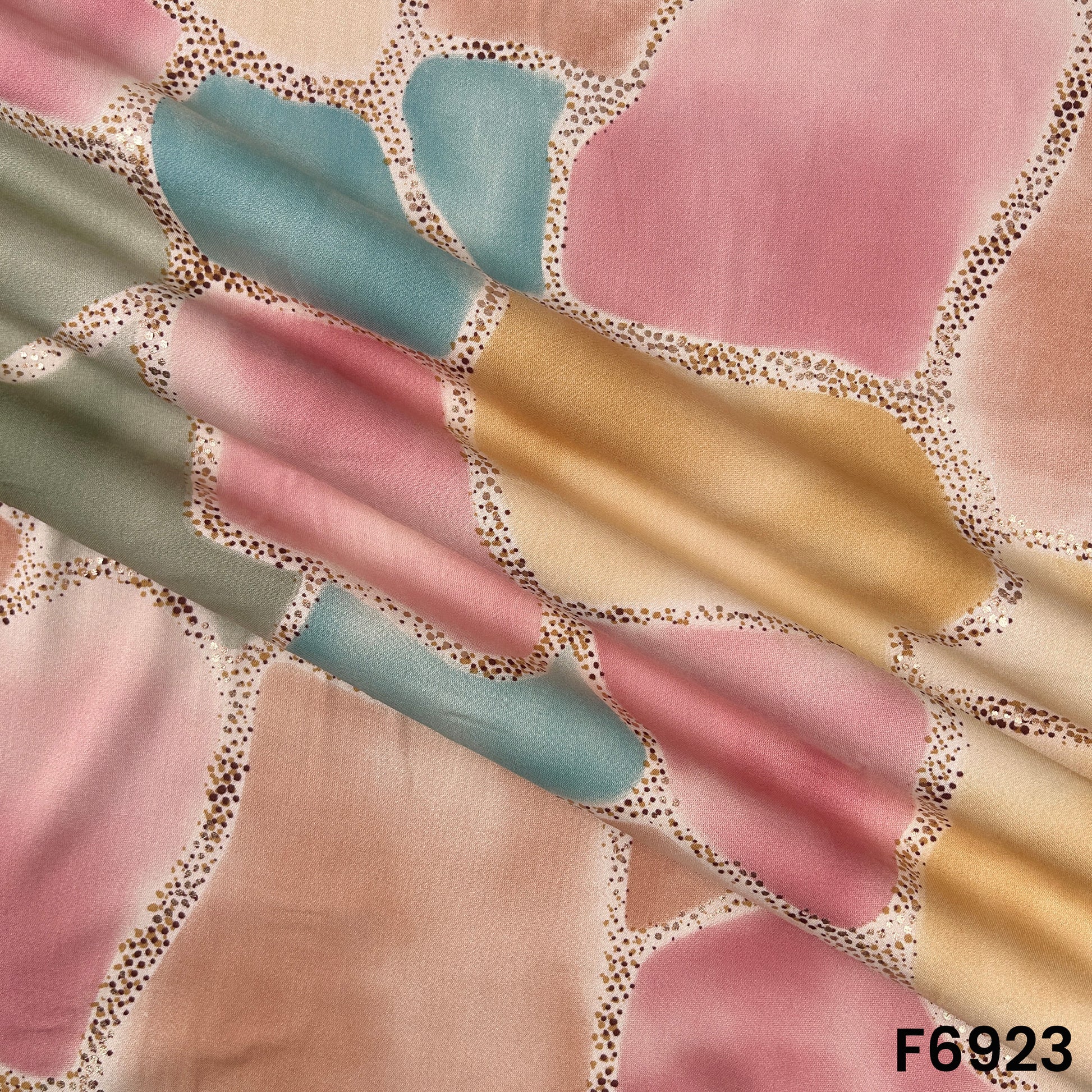 Draped F6923 rayon fabric highlighting fluid folds, pastel shades and elegant foil border detailing