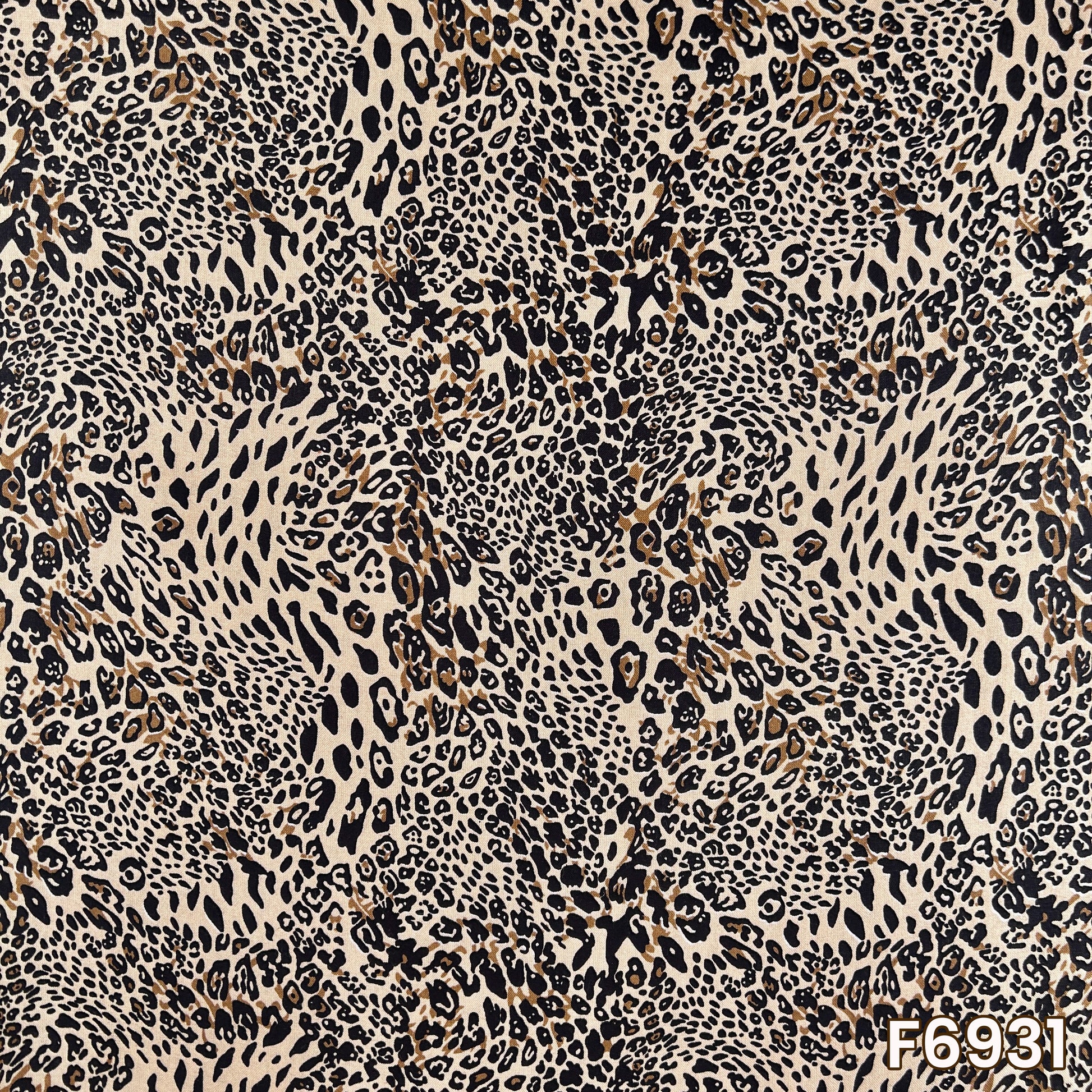 Close pattern view of F6931 showing dense animal markings, natural beige tones and bold black contrast
