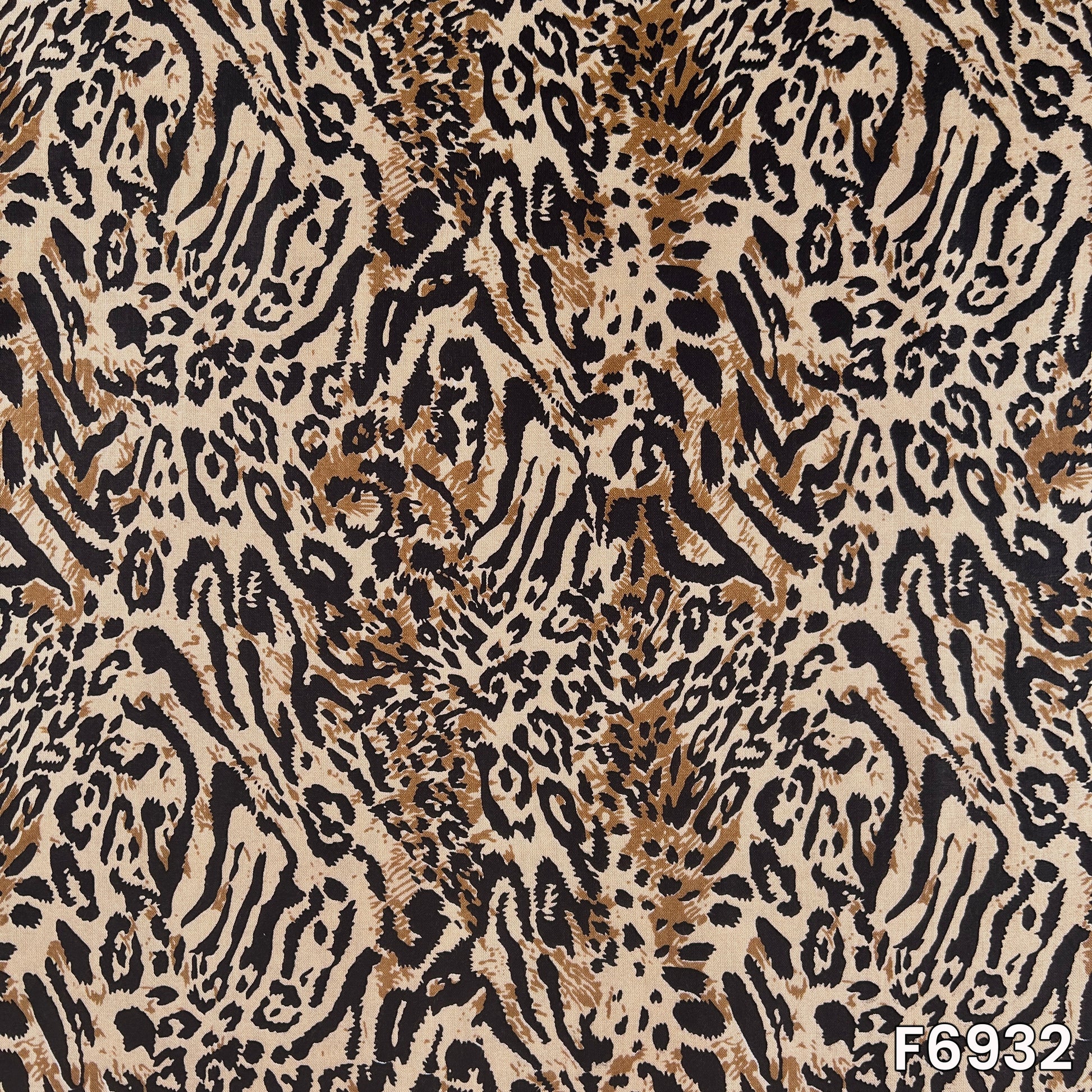 Close pattern view of F6932 showing sharp black strokes, warm beige base and wildlife-inspired detailing