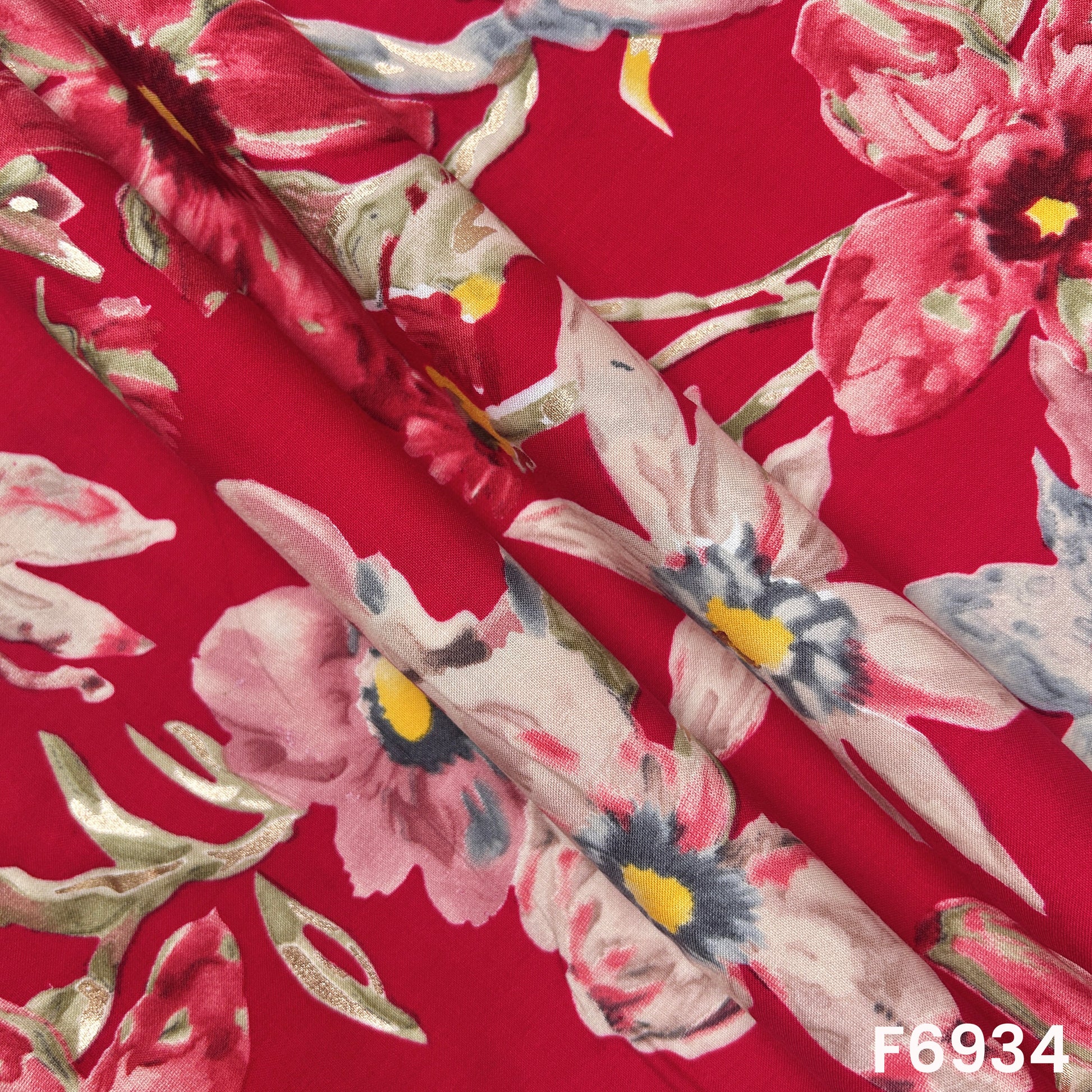Close folded view of F6934 rayon fabric showing smooth drape, glossy accents and elegant botanical placement