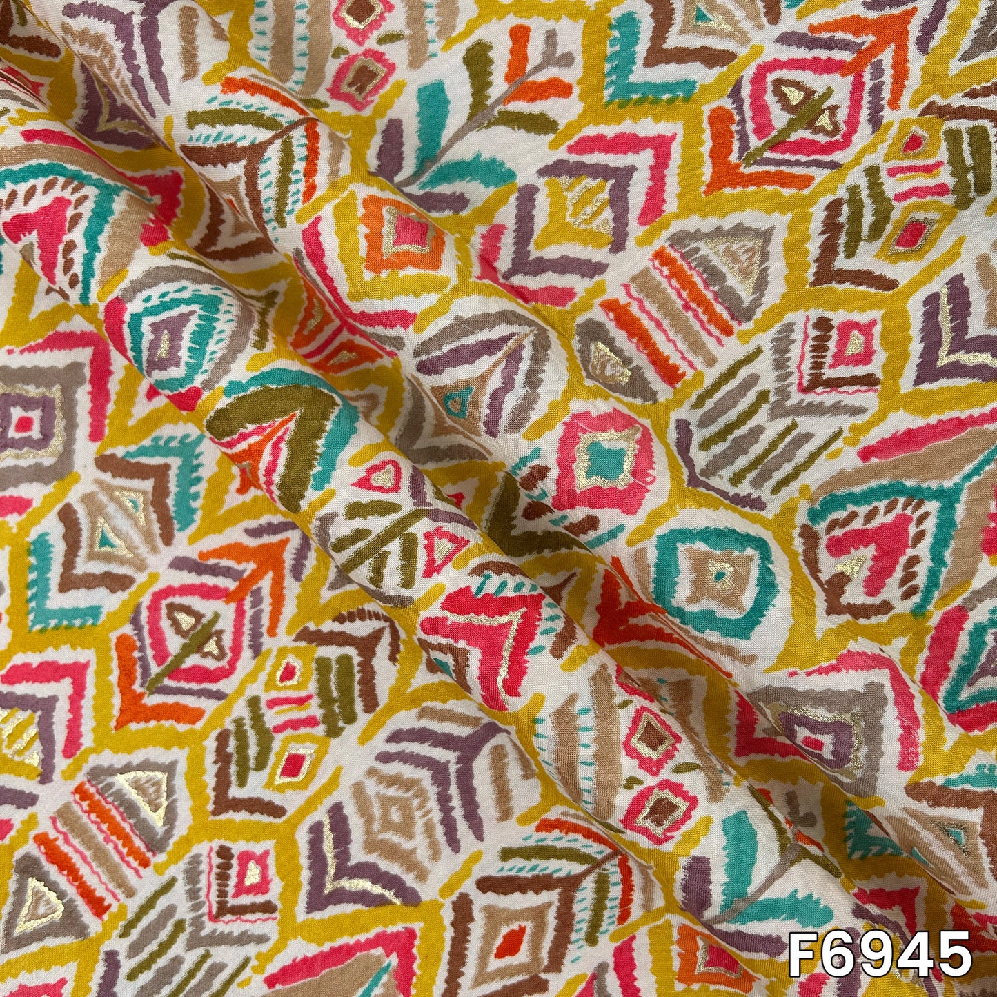 Close-range image highlighting the smooth drape, detailed motifs and delicate foil shimmer of design F6945