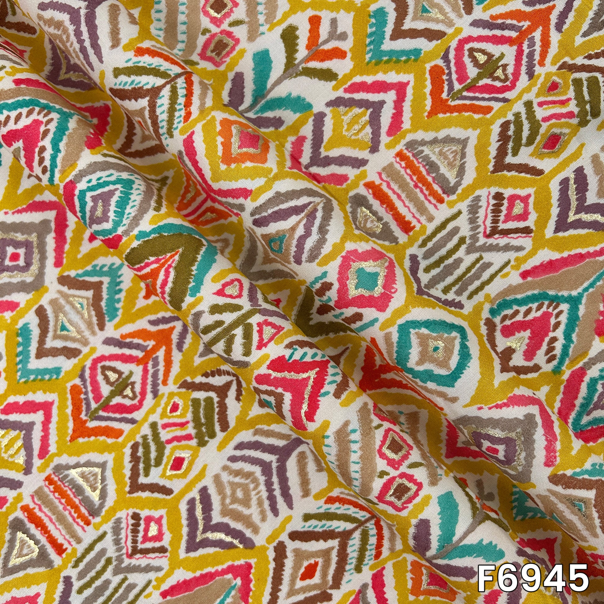 Close-range image highlighting the smooth drape, detailed motifs and delicate foil shimmer of design F6945