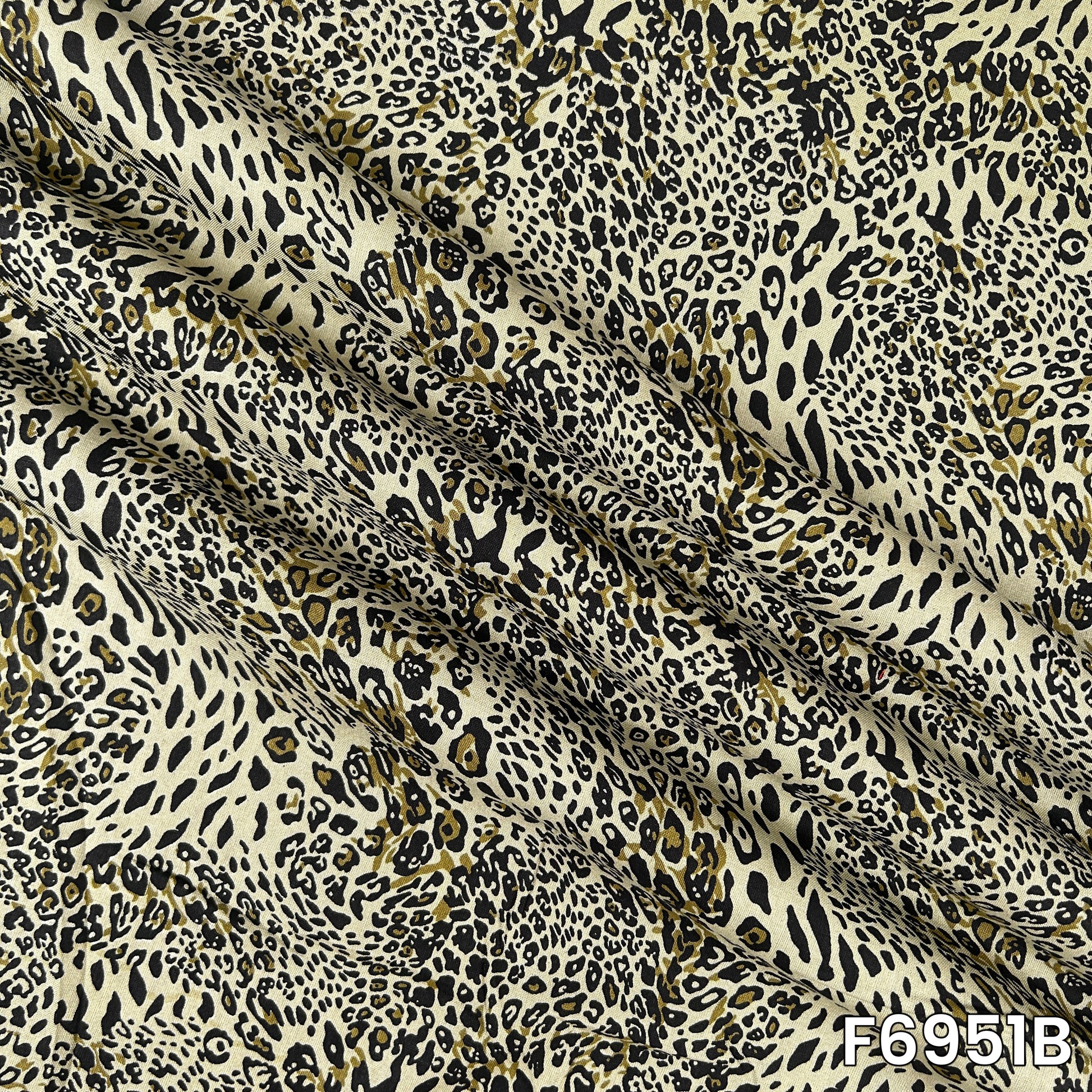 Magnified olive F6951B fabric image highlighting irregular spots, fluid folds and lightweight texture