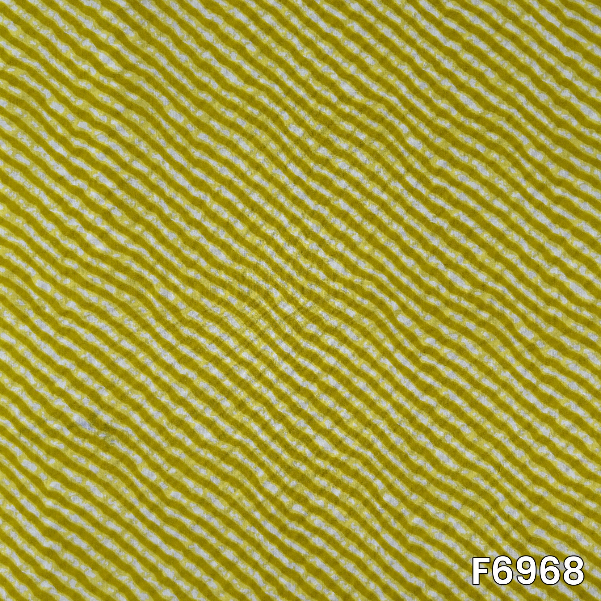 Close pattern view of F6968 showing fine white wavy lines across a bright mustard cotton base