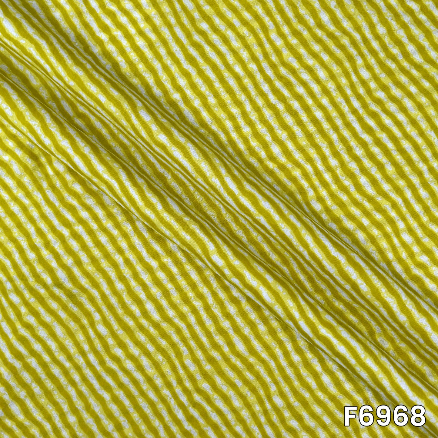 Draped F6968 cotton fabric highlighting natural folds, lightweight feel and clean striped print placement