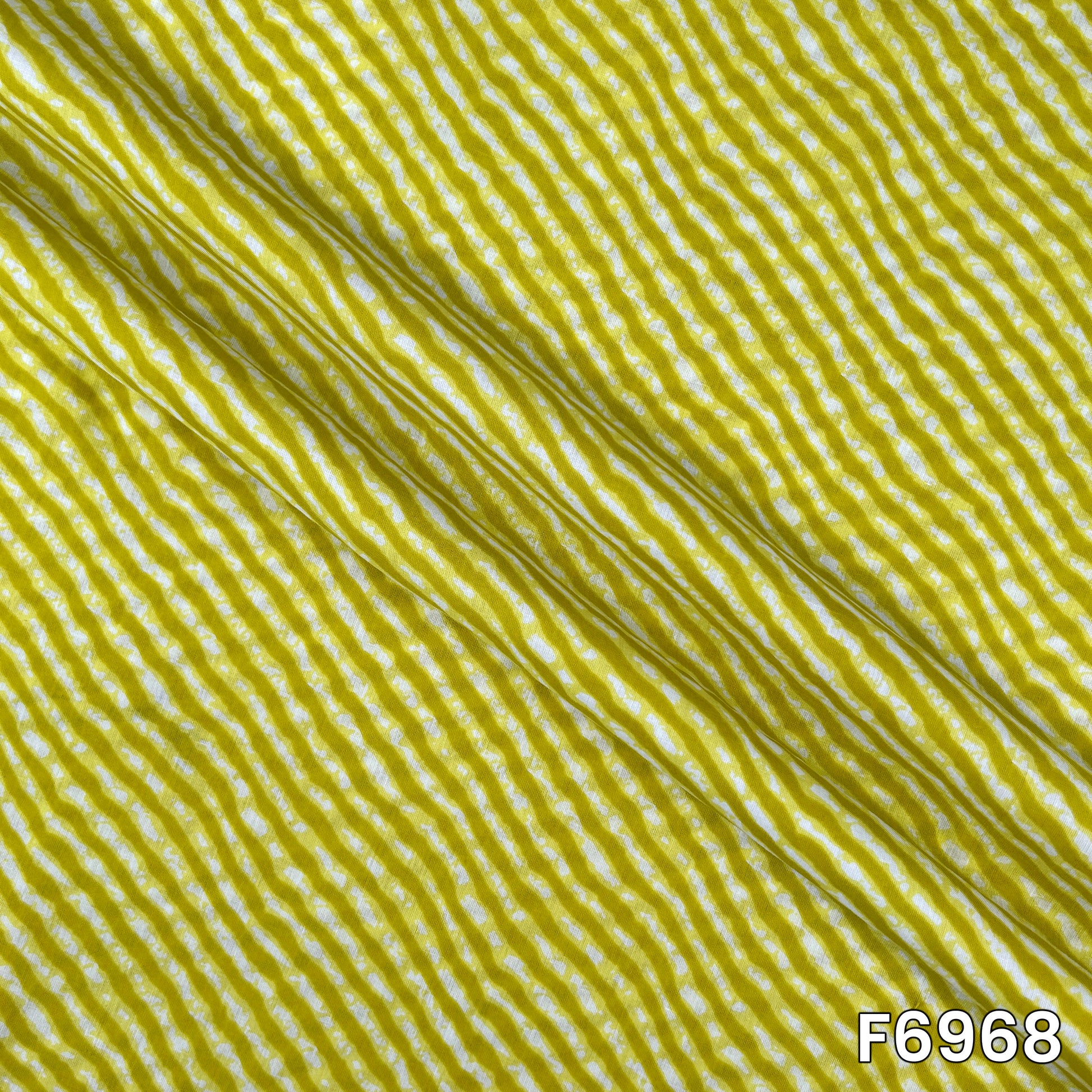 Draped F6968 cotton fabric highlighting natural folds, lightweight feel and clean striped print placement