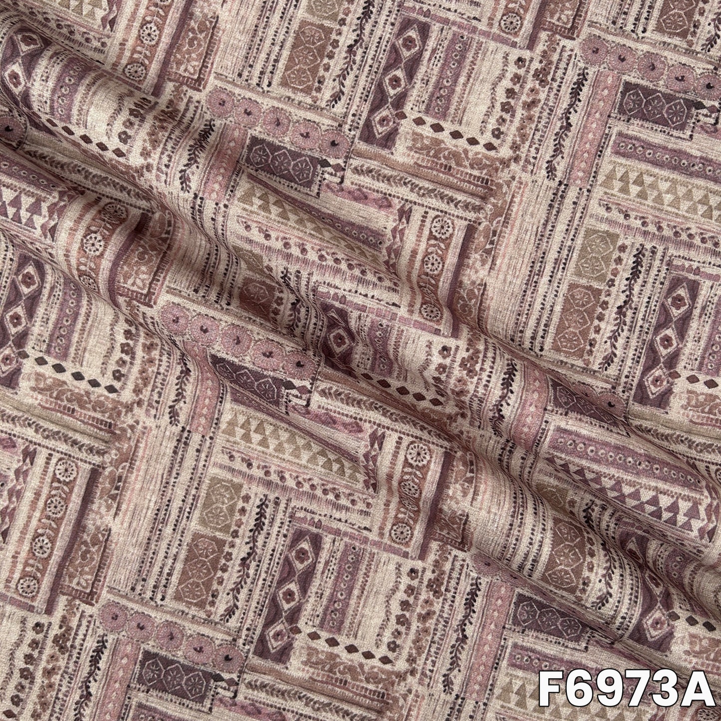 Close view of F6973A showing intricate patchwork print, soft earthy shade and natural linen texture