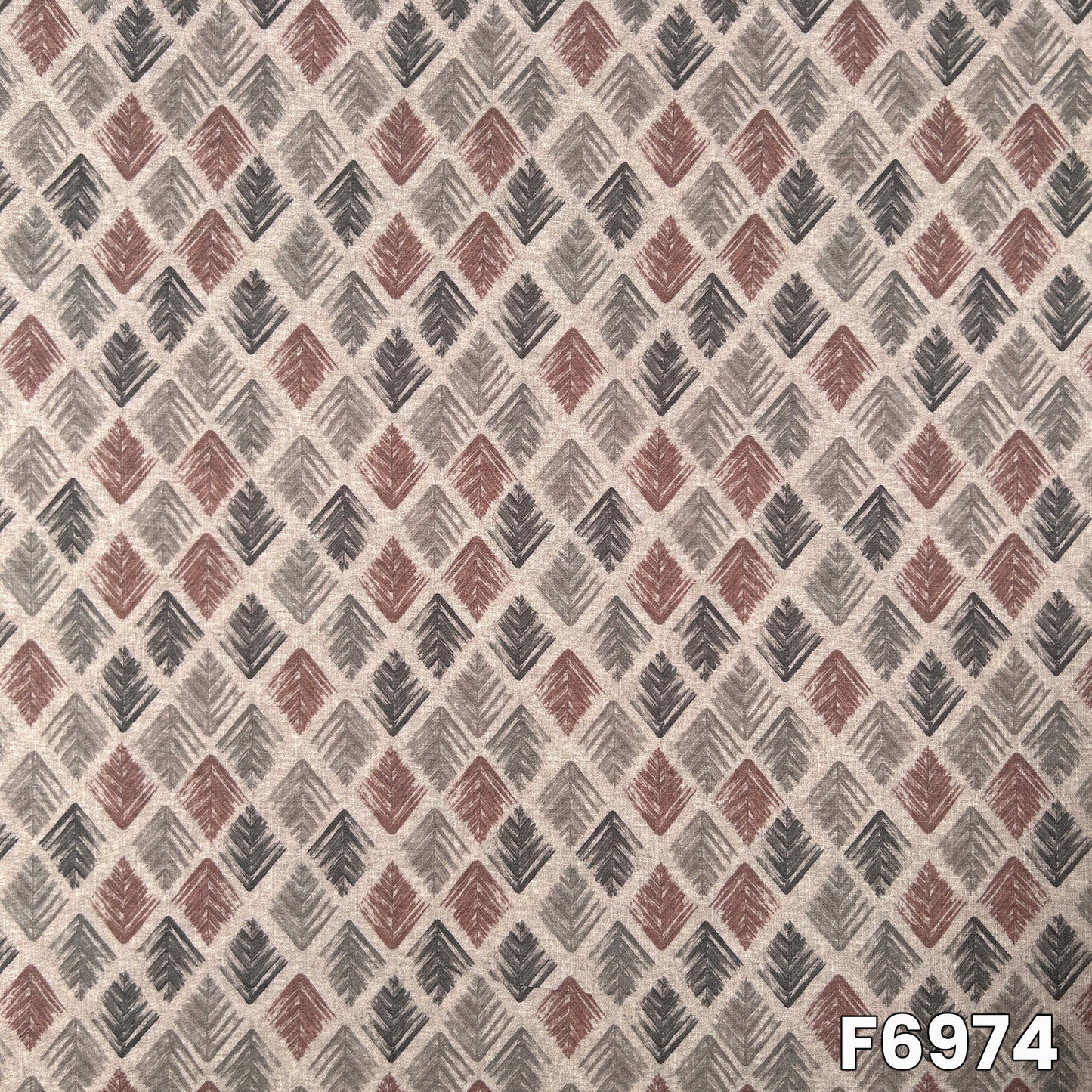 Close pattern view of F6974 showing diamond-style leaf motifs, soft earthy tones and clean print alignment