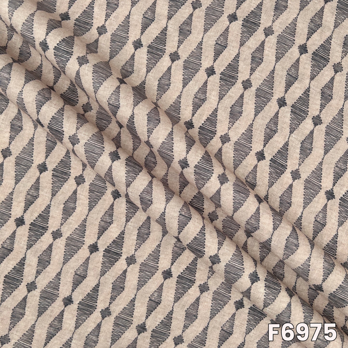 Draped F6975 semi linen fabric highlighting soft folds, natural beige tone and contemporary print finish