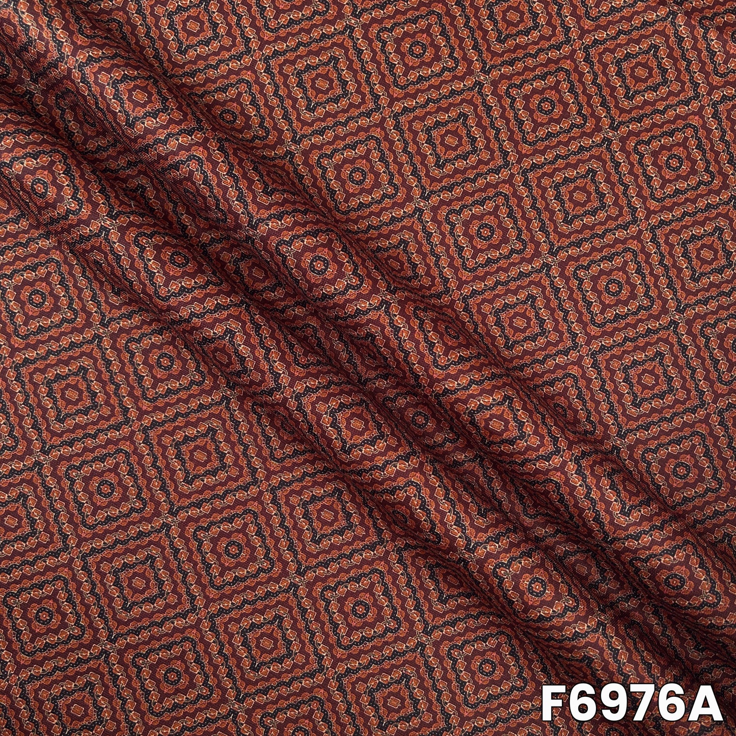 Close view of F6976A showing neat repeated patterns, earthy rust shade and soft linen texture