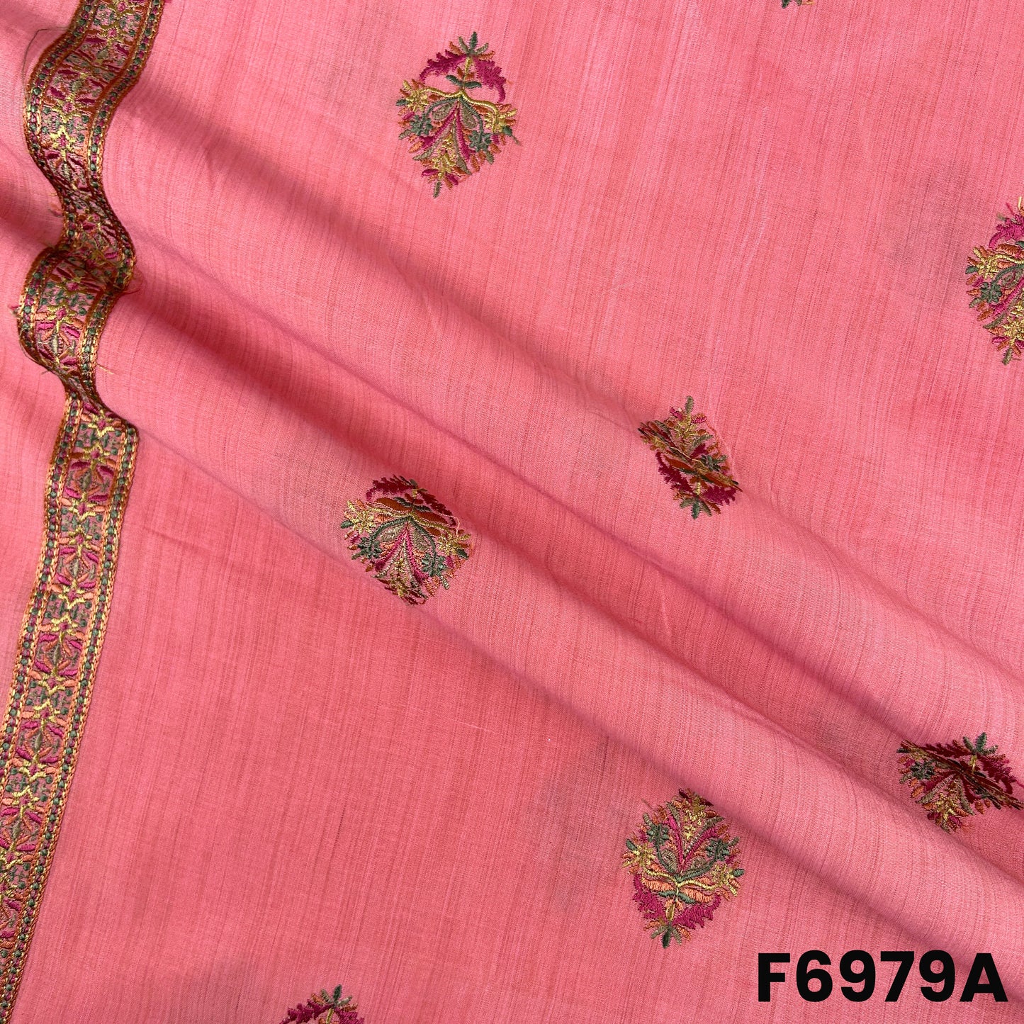 Close view of F6979A showing scattered embroidered motifs, gentle folds and refined thread detailing