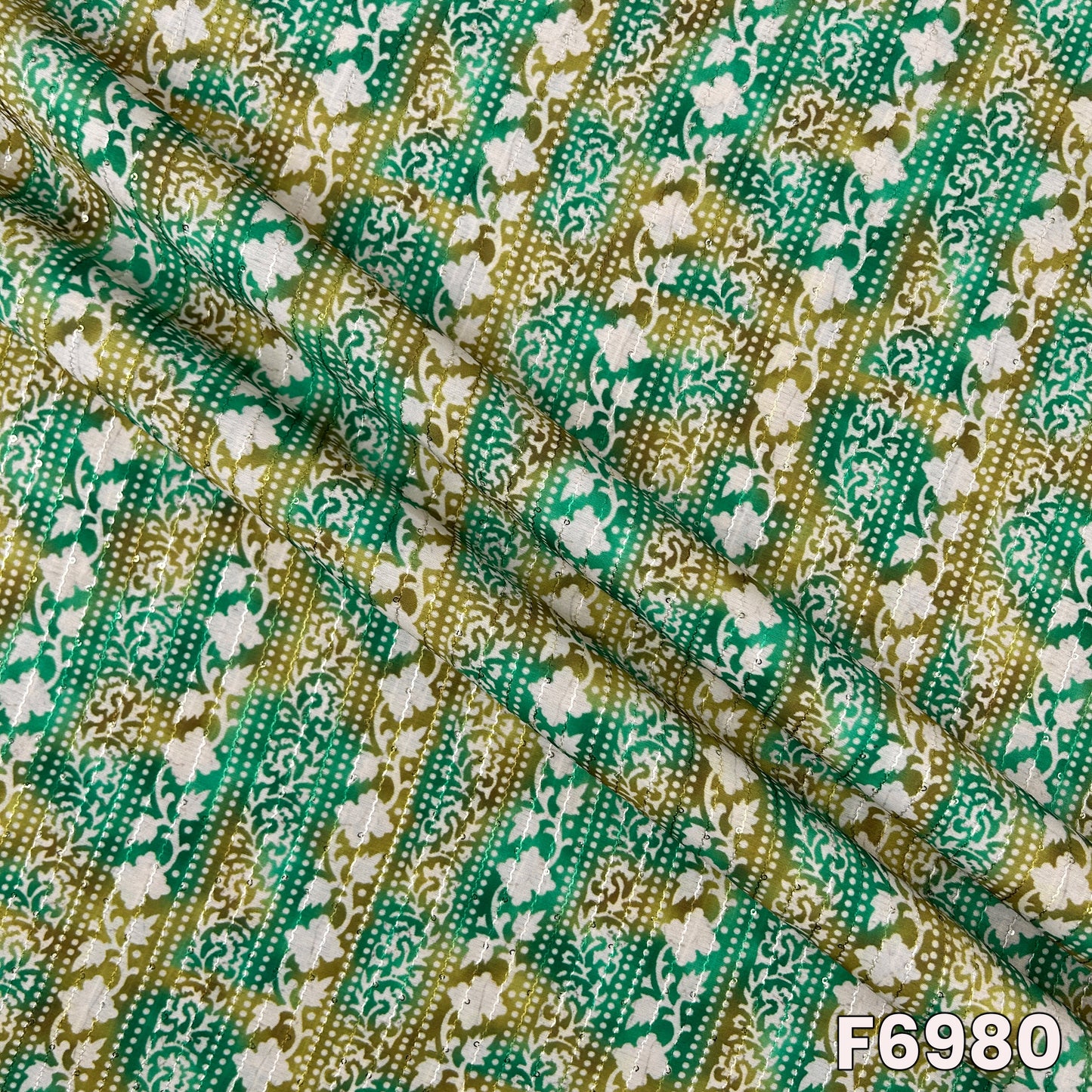 Draped F6980 semi silk fabric highlighting smooth folds, soft shimmer and rich ethnic print texture