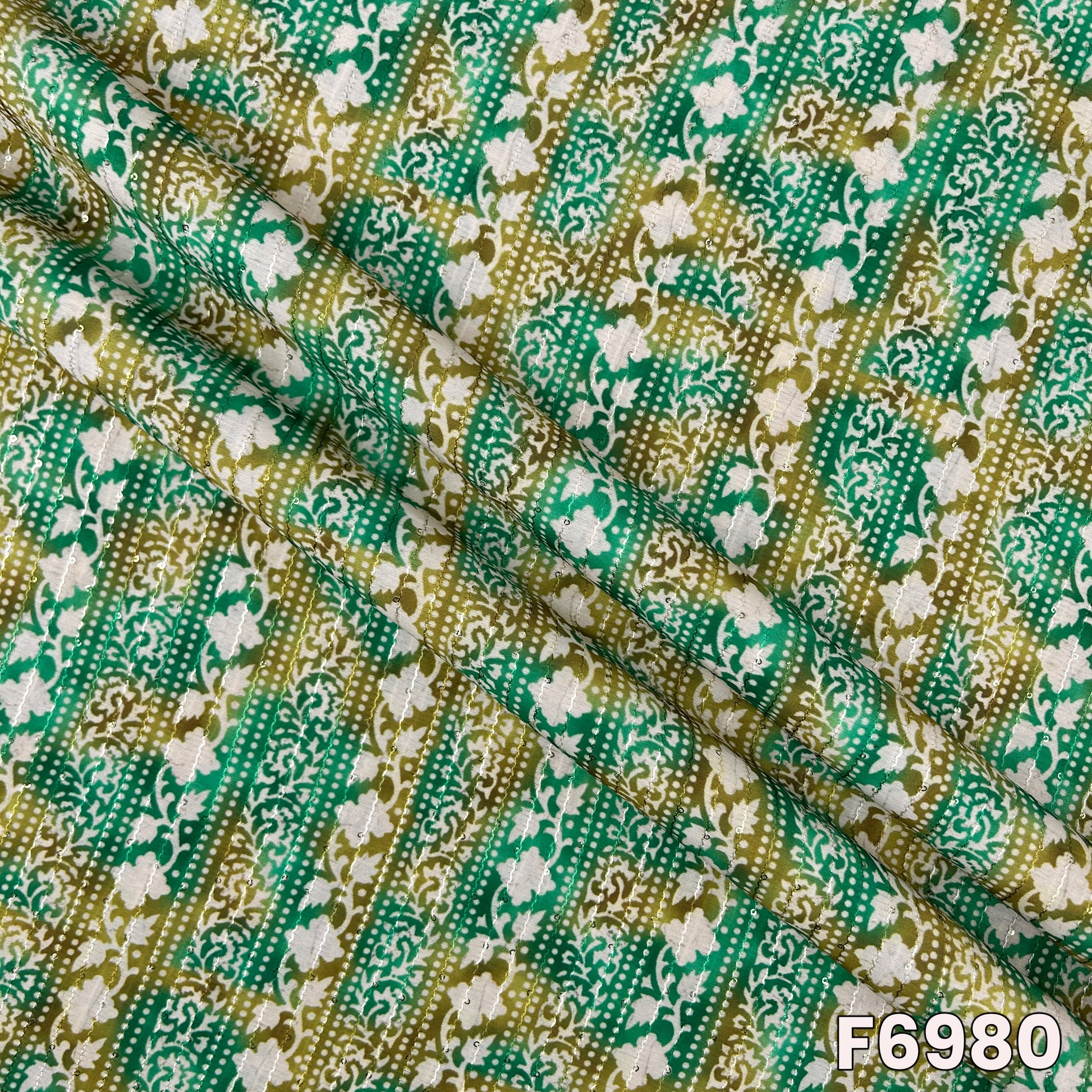 Draped F6980 semi silk fabric highlighting smooth folds, soft shimmer and rich ethnic print texture