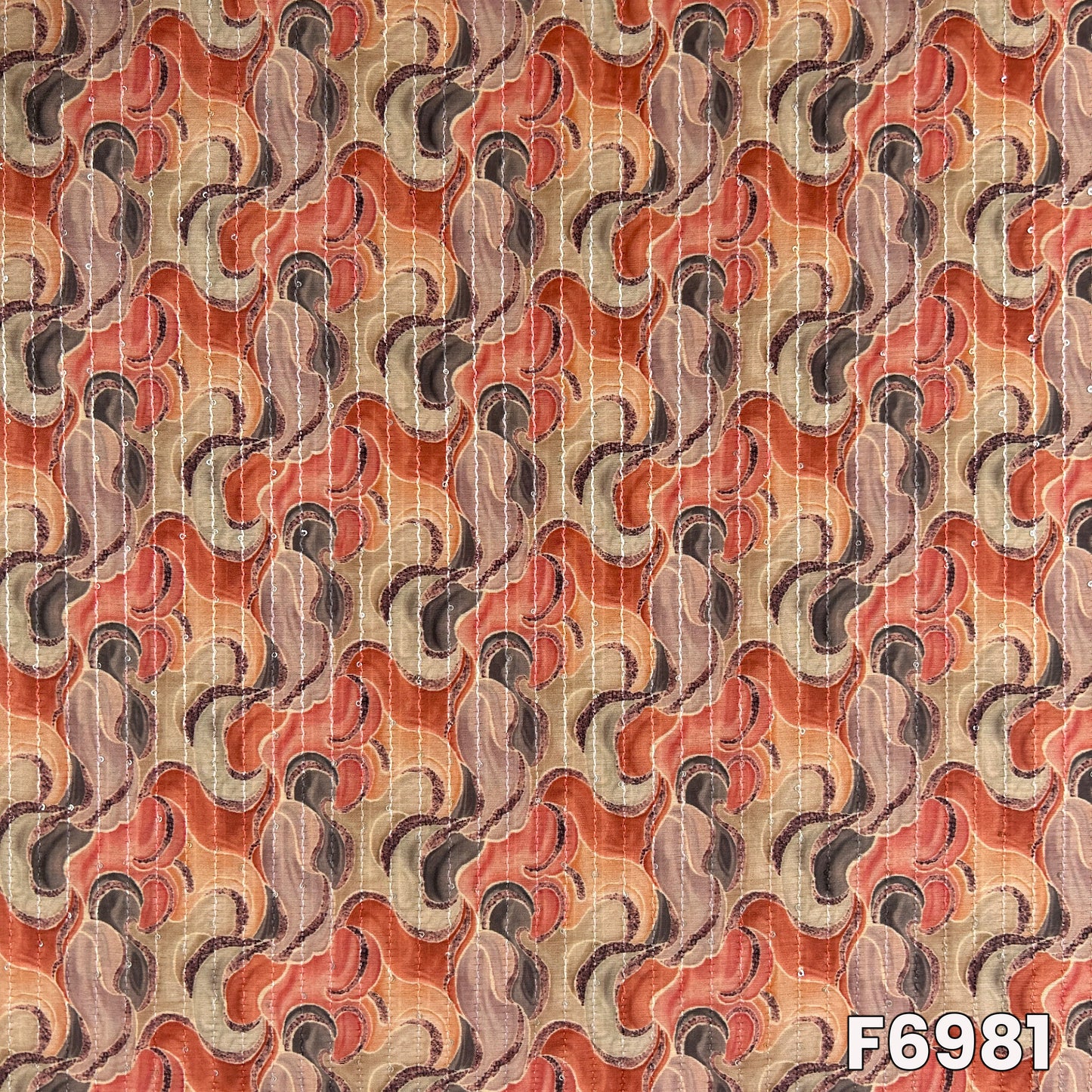 Close pattern view of F6981 showing flowing wave artwork, warm earthy tones and delicate sequins accents