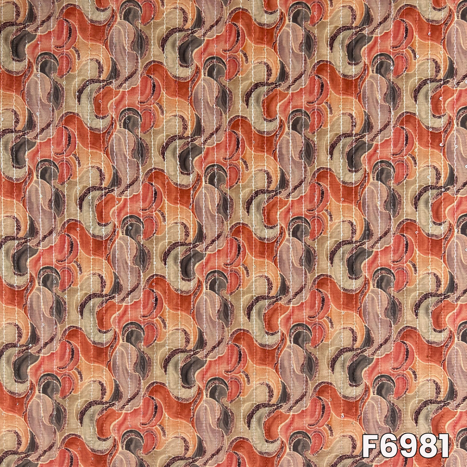 Close pattern view of F6981 showing flowing wave artwork, warm earthy tones and delicate sequins accents