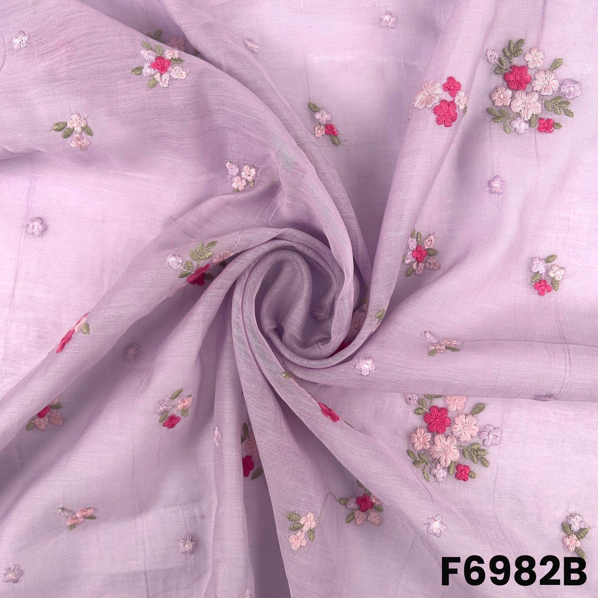 Draped F6982B fabric highlighting pastel purple folds, tiny stitched flowers and a soft airy finish