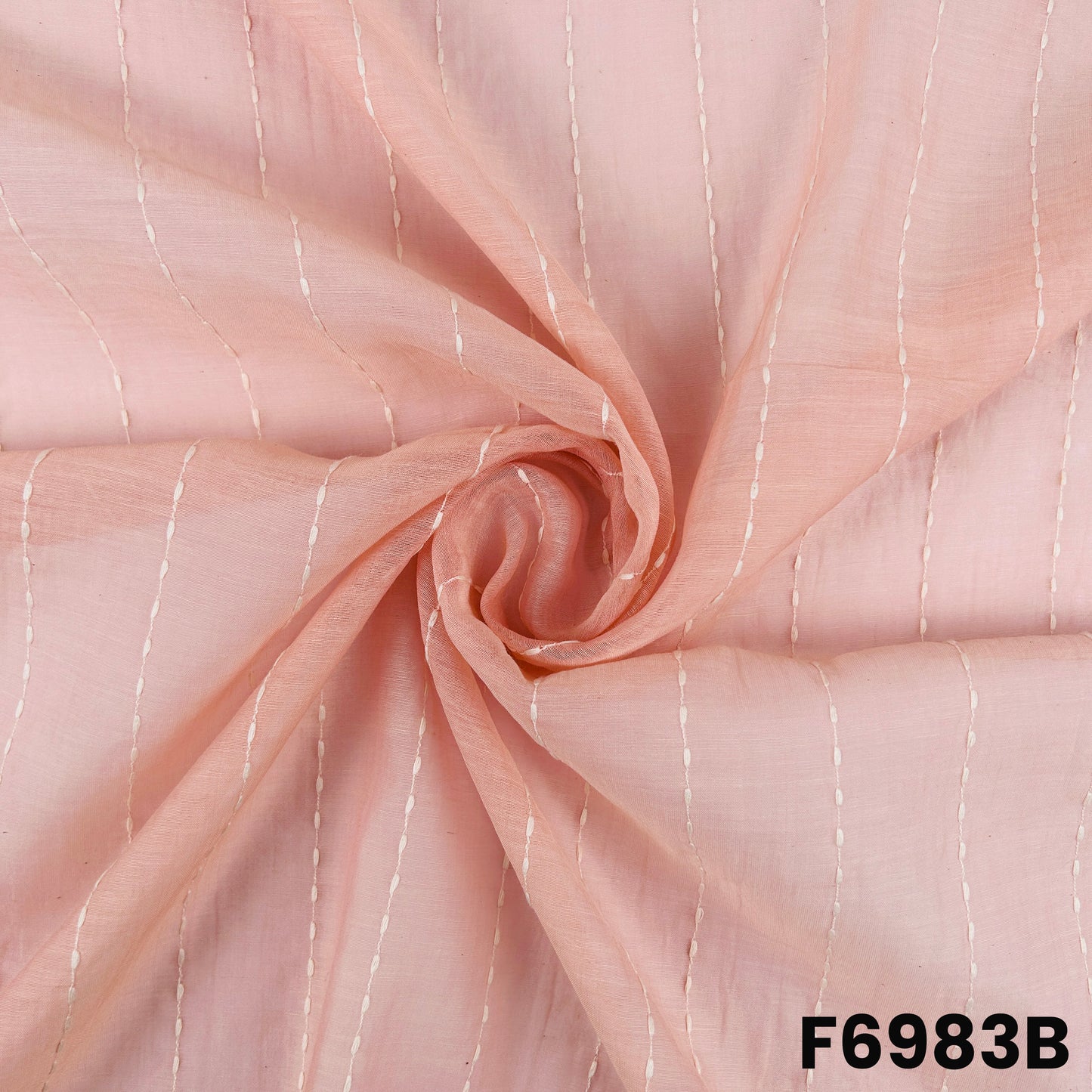 Draped F6983B fabric highlighting pastel pink shine, lightweight flow and refined thread placement