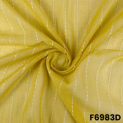 Close-up of F6983D displaying sunny yellow folds, fine stitched lines and soft fabric movement