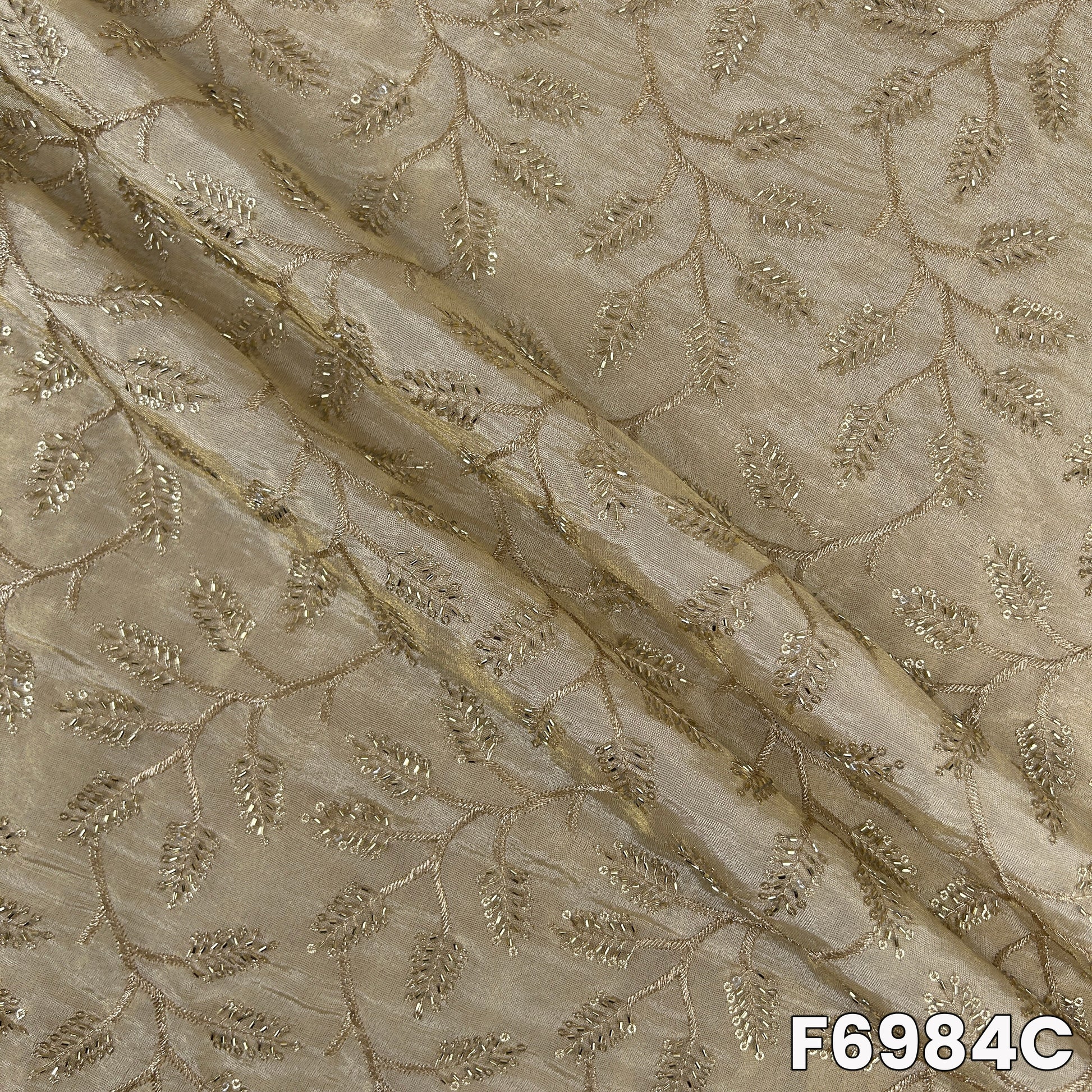 Detailed F6984C surface showing pale metallic sheen, floral embroidery and refined occasion-wear finish
