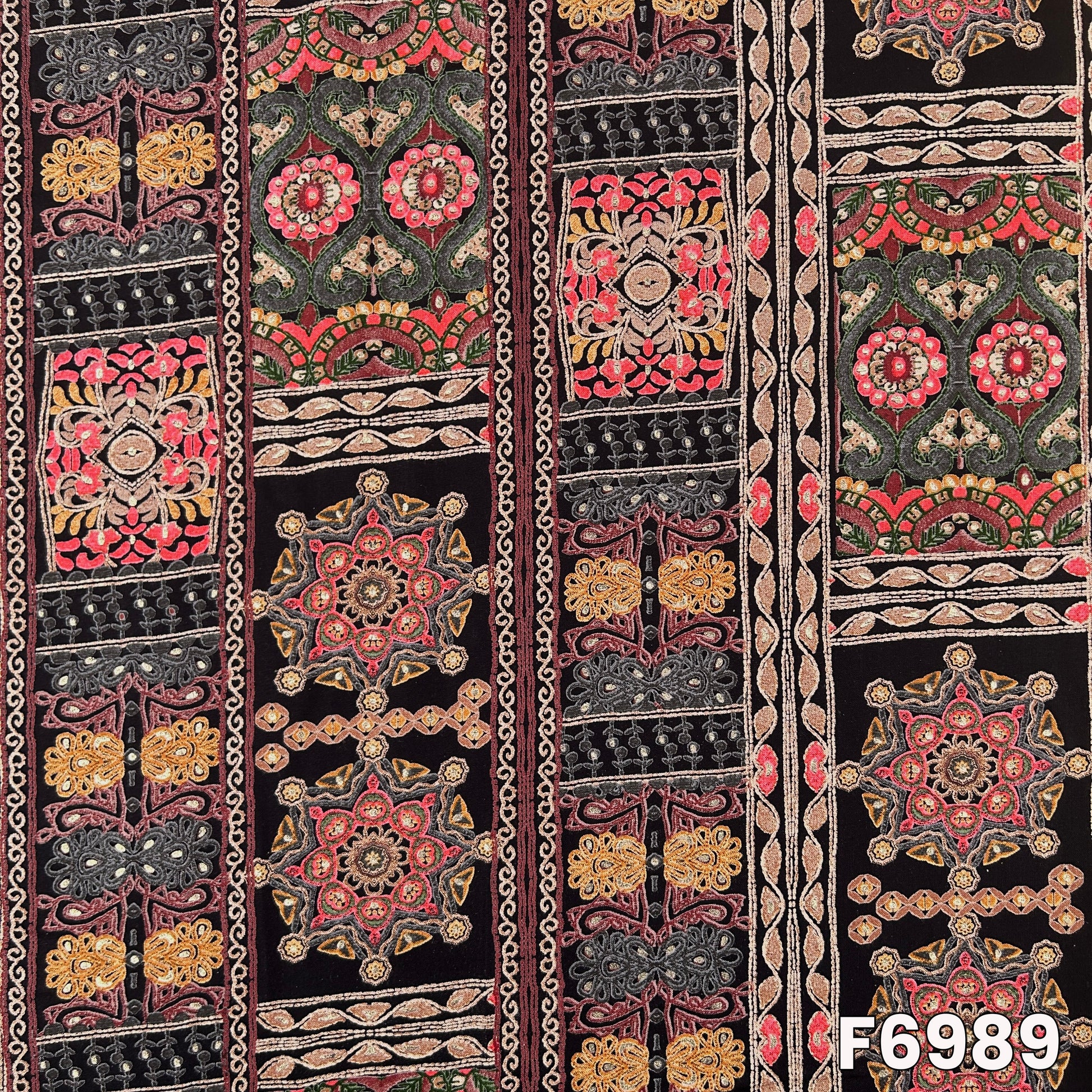 Detailed fabric view of F6989 showing medallion blocks, floral accents and multicolor traditional artwork