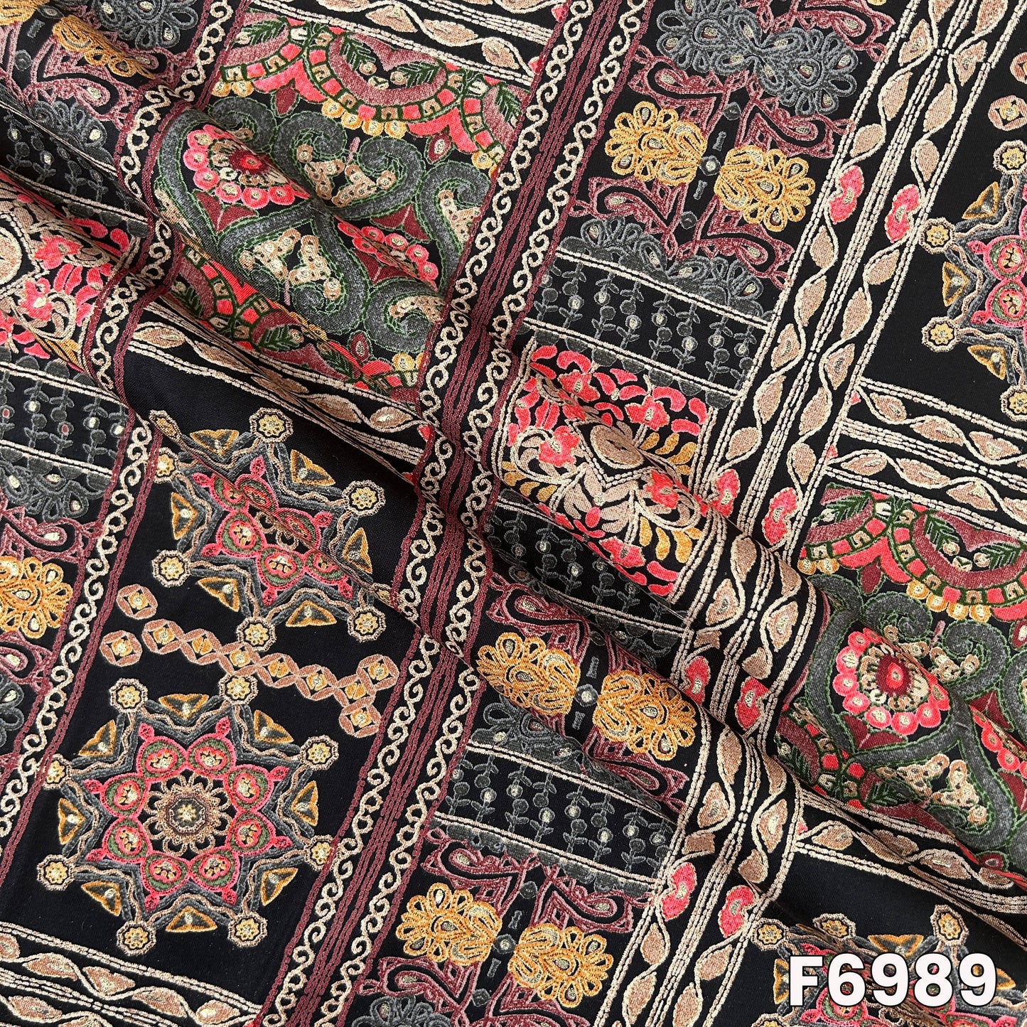 Draped F6989 rayon fabric highlighting smooth folds, decorative border placement and subtle foil finish