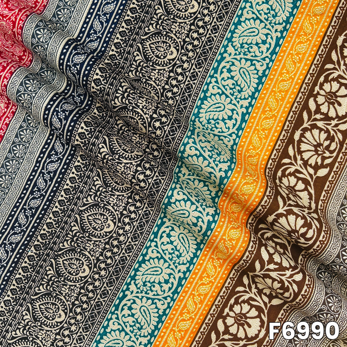 Draped F6990 rayon fabric highlighting smooth folds, lightweight flow and detailed ethnic print placement