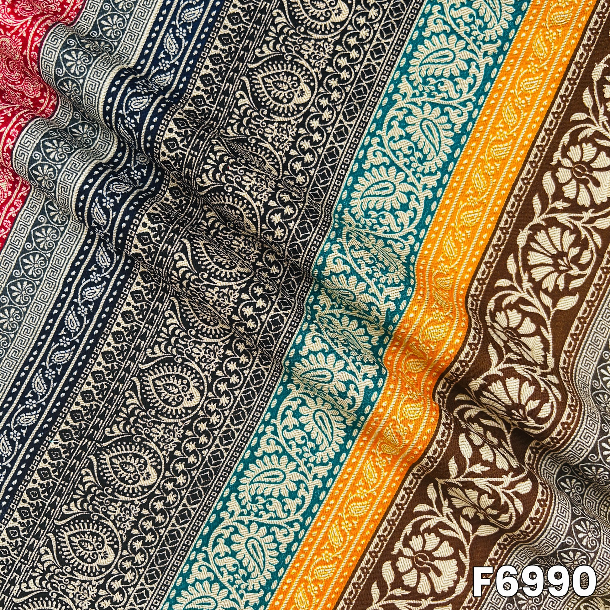Draped F6990 rayon fabric highlighting smooth folds, lightweight flow and detailed ethnic print placement