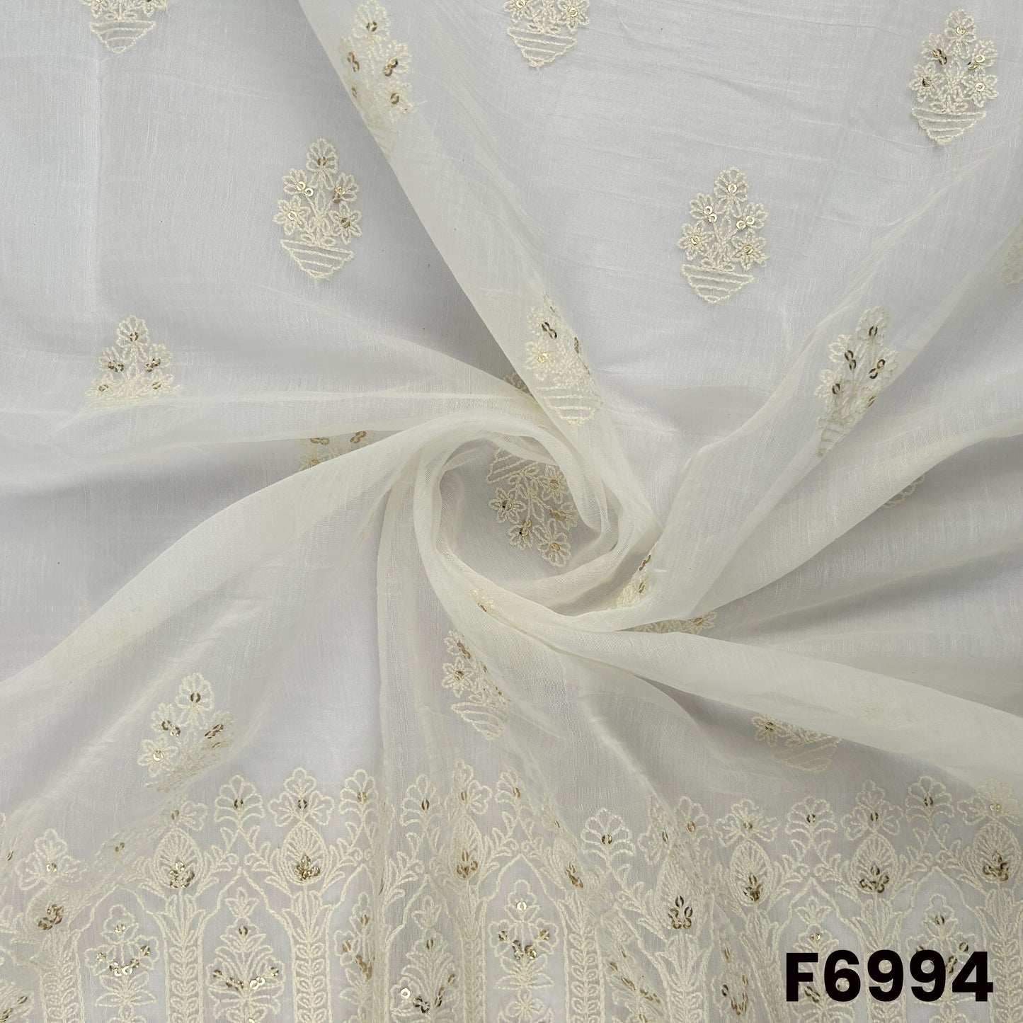 Draped F6994 Chanderi Silk fabric showing airy folds, scattered floral butti work and a graceful lightweight sheen