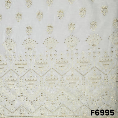 Close view of F6995 showing grand border embroidery, fine threadwork and shimmering sequins on an off-white base