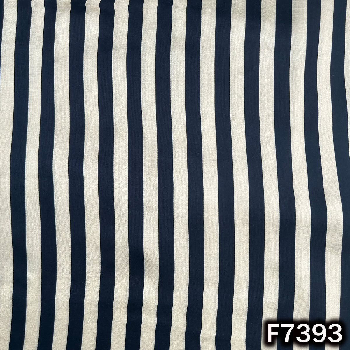 Modal satin fabric with bold black ivory stripes
