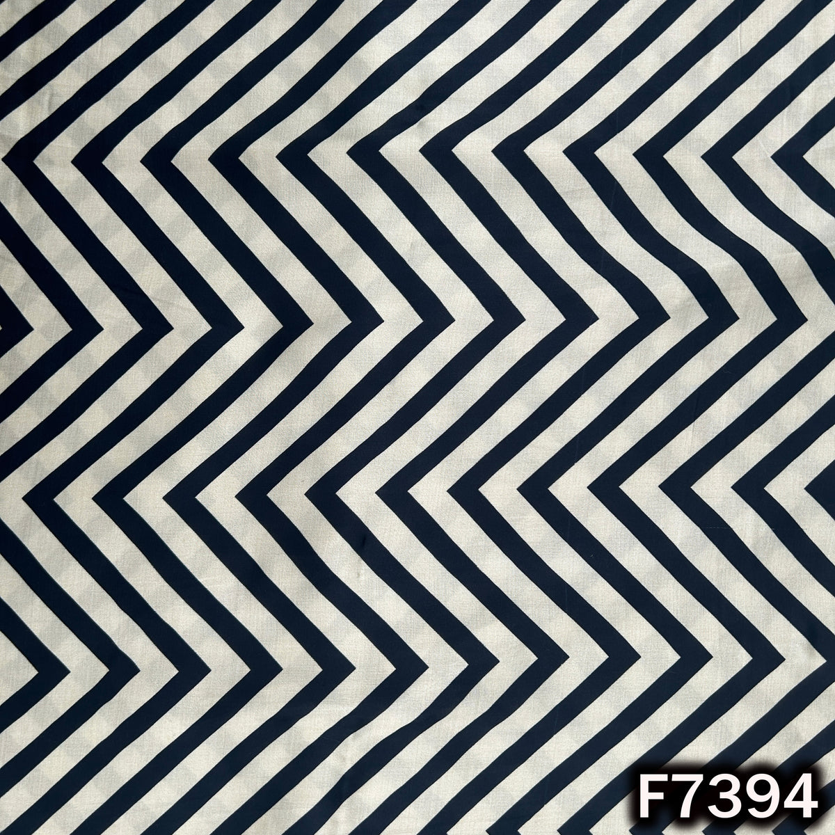 Modal satin fabric with bold black chevron pattern
