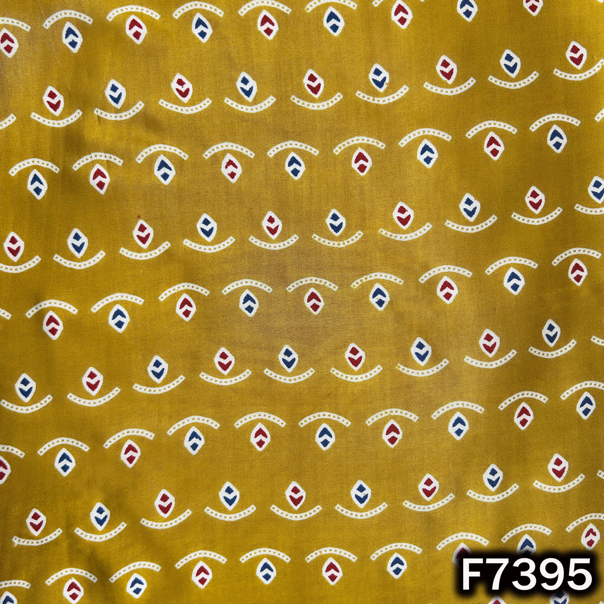 Yellow modal satin fabric with multicolor geometric motifs
